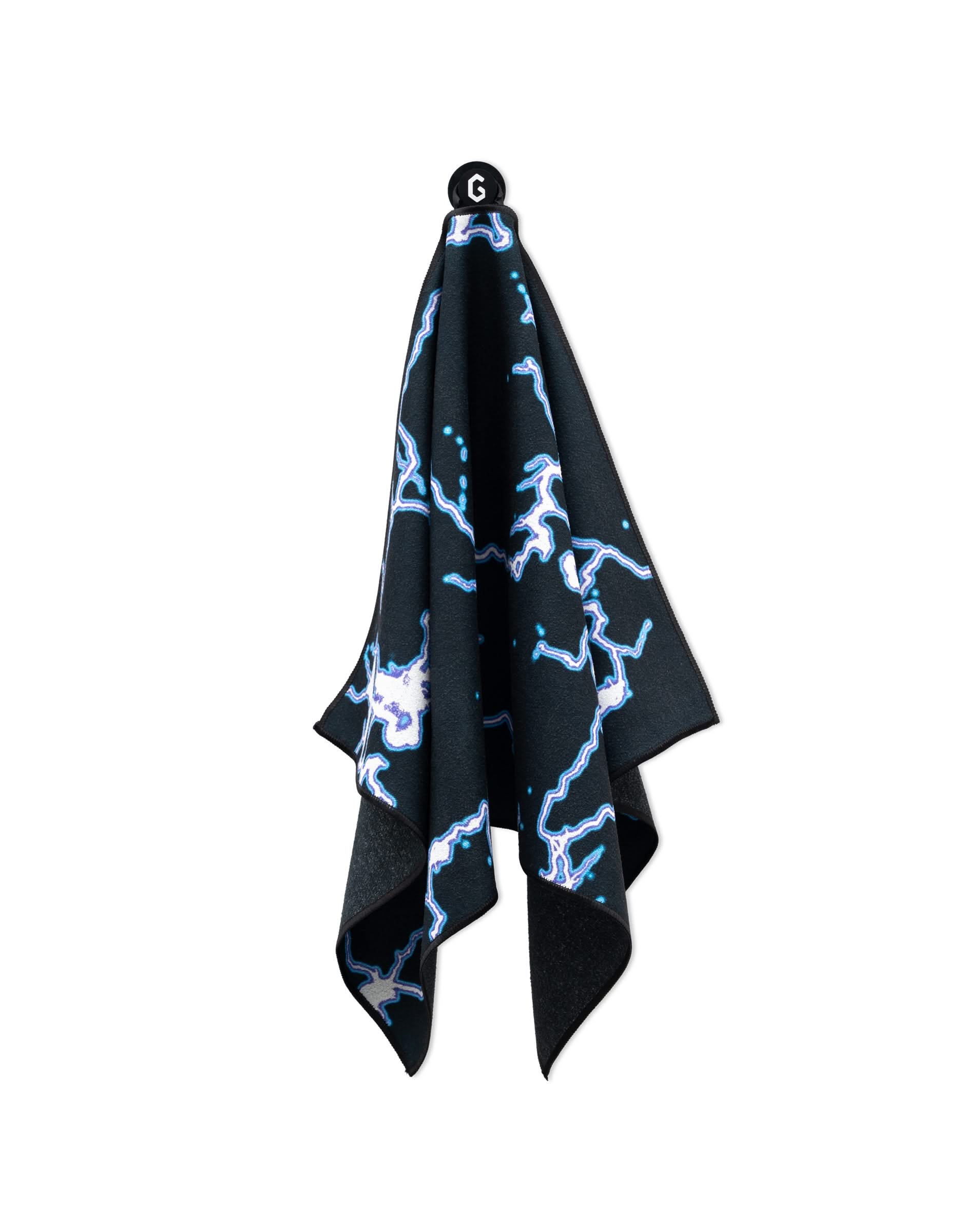 The GEOMETRY Magna - Electric Flash black gym towel featuring a blue and white lightning bolt pattern hangs on a hook labeled G against a white background.
