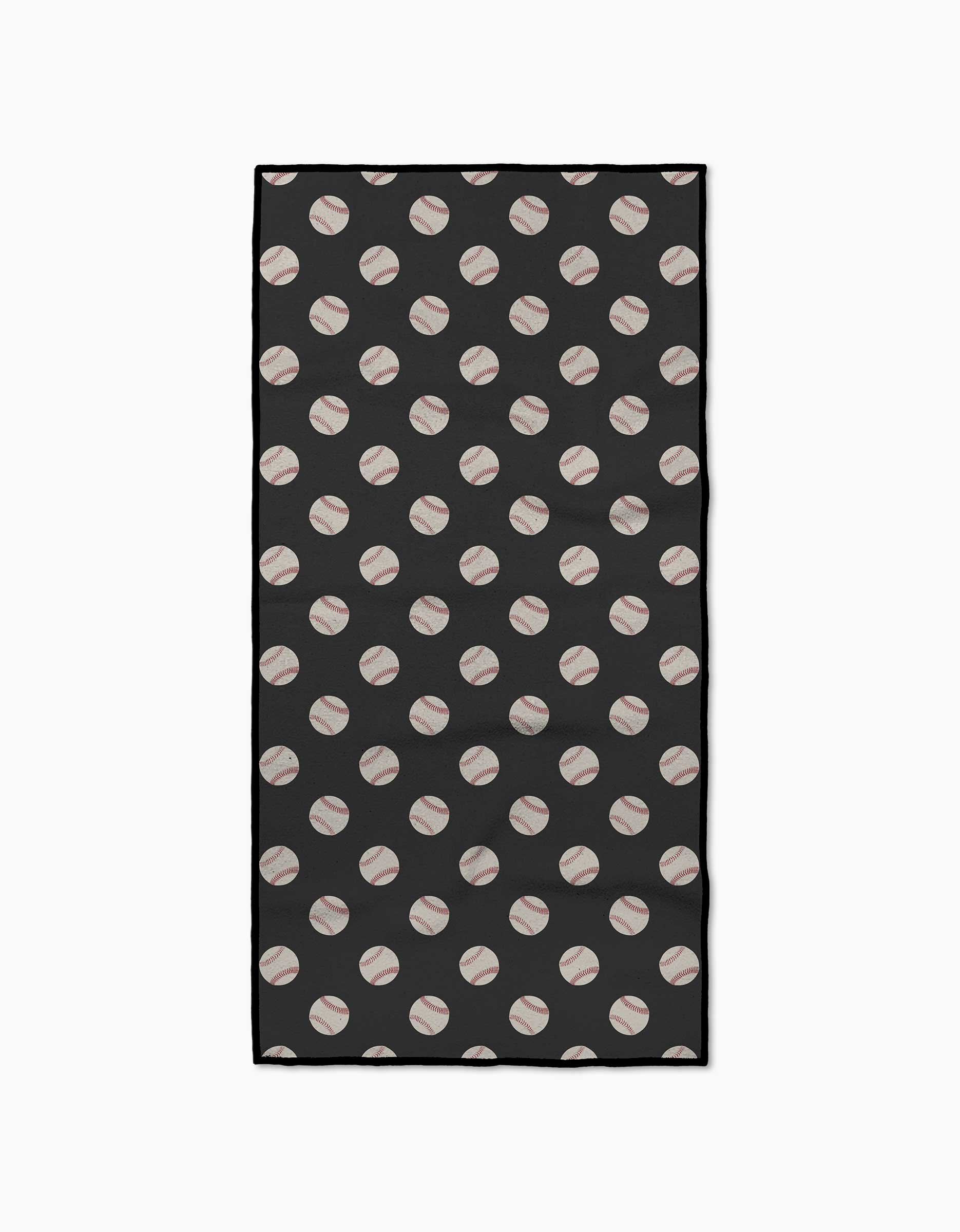 The Geometry Fastball Fitness Towel is a rectangular black towel featuring a repeating diagonal pattern of white baseballs with red stitching, made from ultra-absorbent recycled materials.