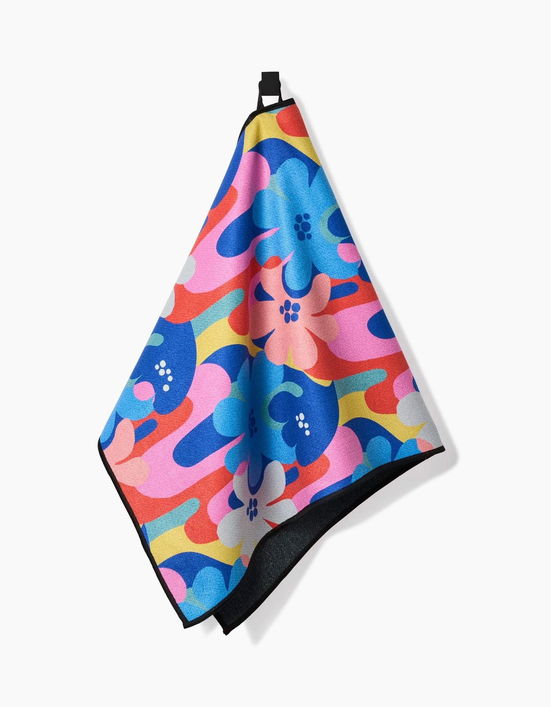 The Masha Volnova “Flower Powers” fitness towel features a colorful abstract floral pattern in pink, blue, red, and yellow. Made from ultra-absorbent recycled materials, it combines style and sustainability with a handy black loop for hanging.
