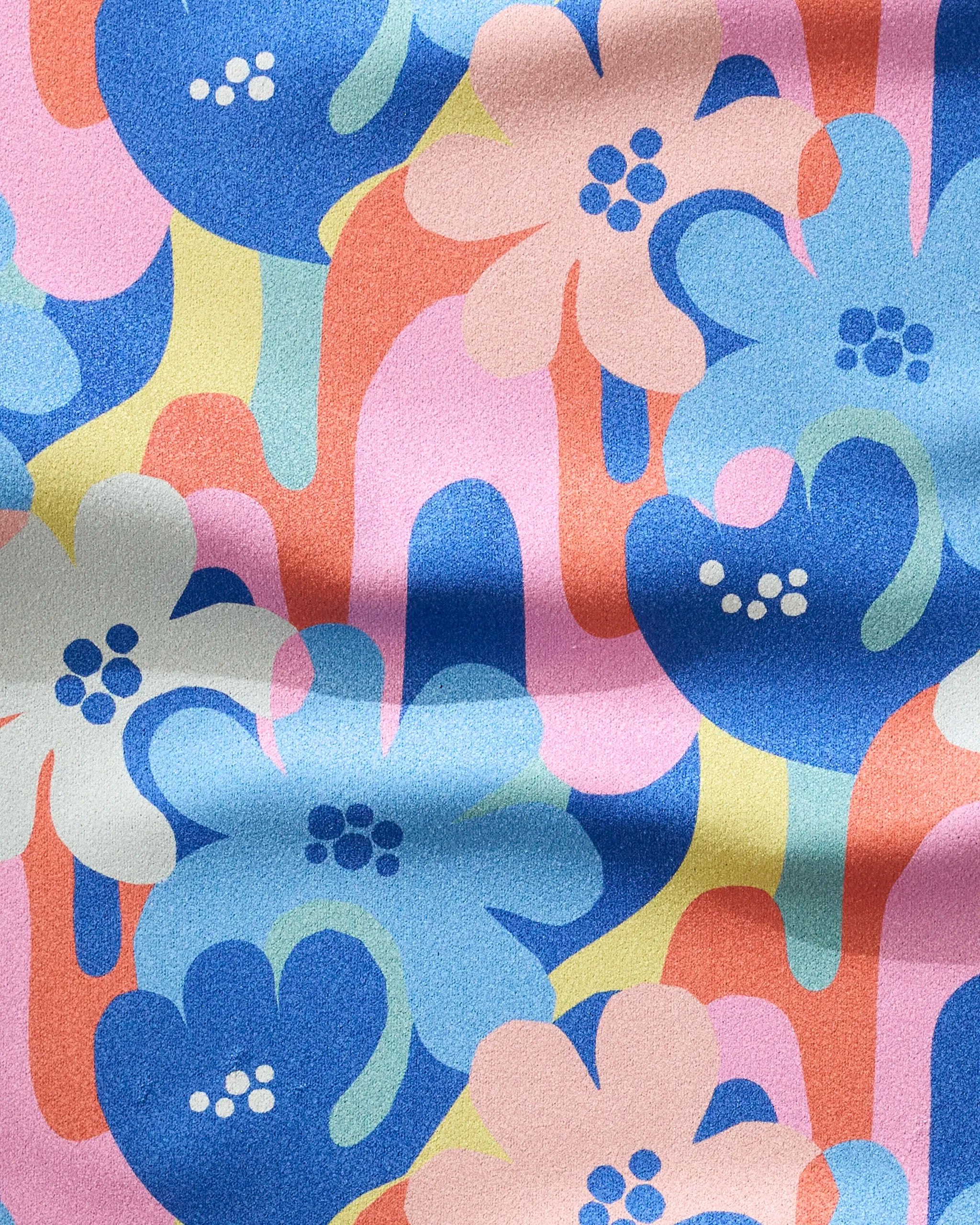 Flower Powers by Masha Volnova features a colorful abstract floral pattern with blue, pink, orange, and yellow flowers on an ultra-absorbent fitness towel made from recycled materials.