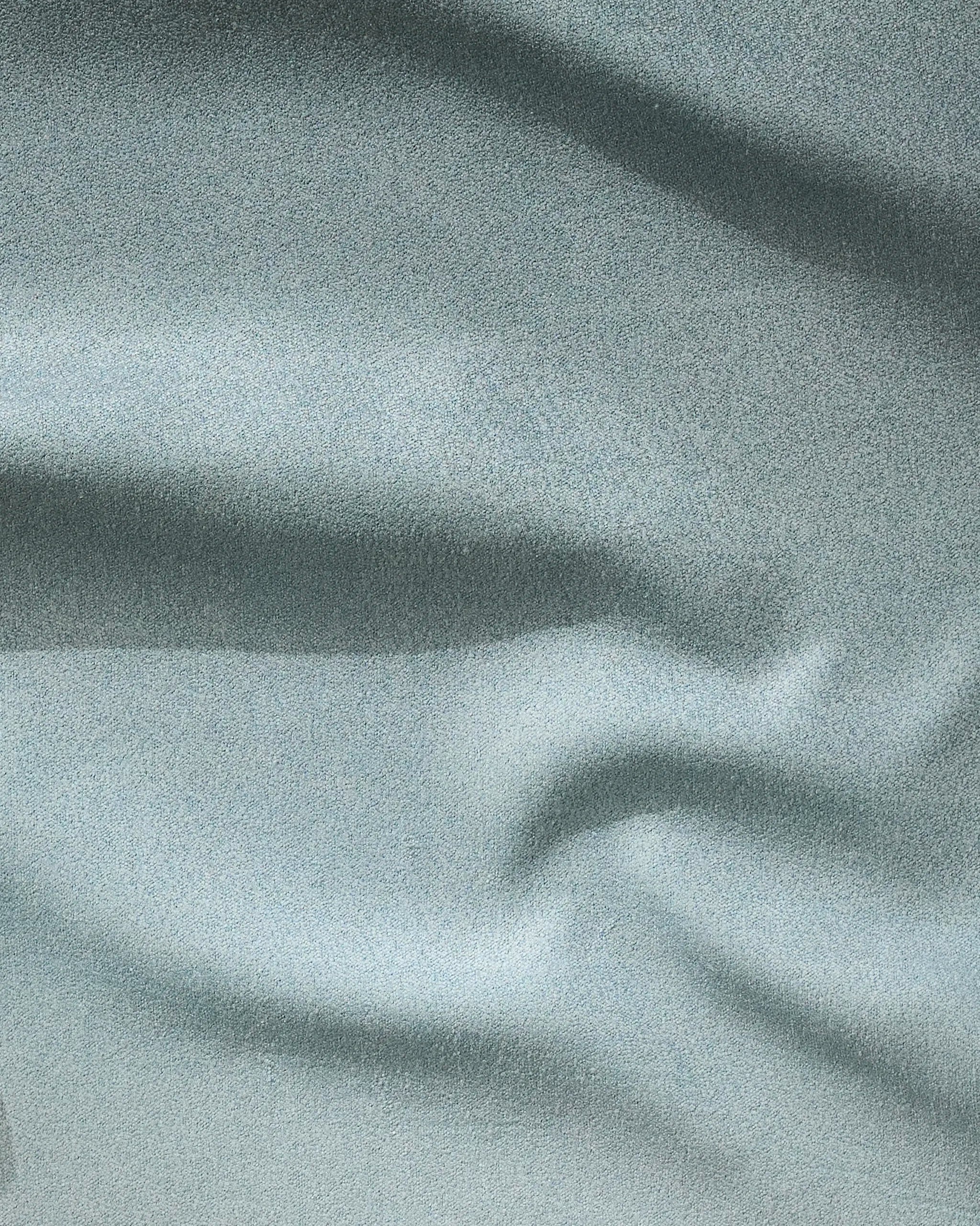 Light gray "Foundation" towel by GEOMETRY features soft, smooth fabric with gentle folds and subtle wavy patterns—ideal as a fast-drying fitness accessory.