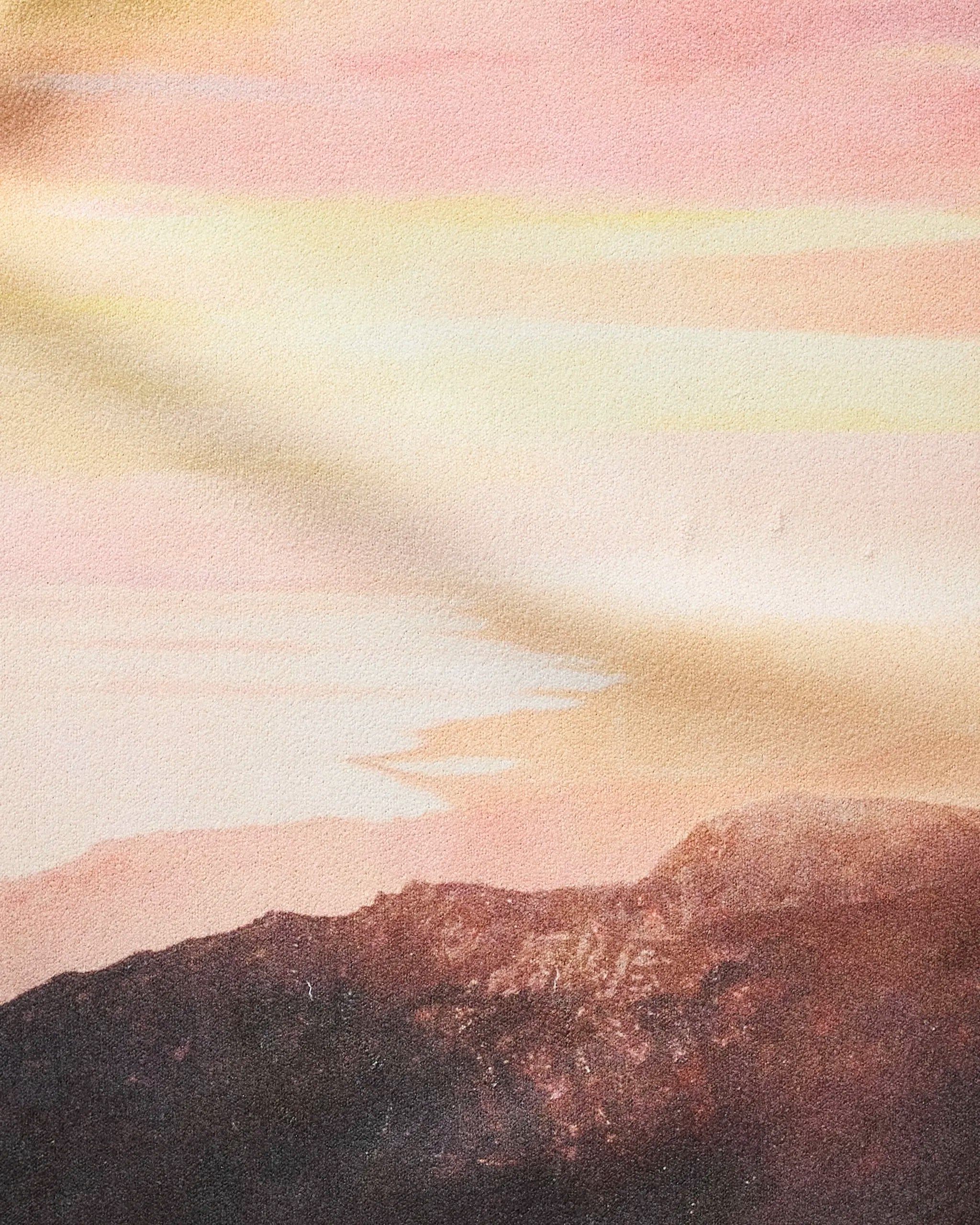 A soft, pastel landscape shows dark mountains beneath a glowing pink and yellow sky, evoking tranquility at sunrise or sunset—qualities reflected in "Her Majesty" by Stefanie Bales.