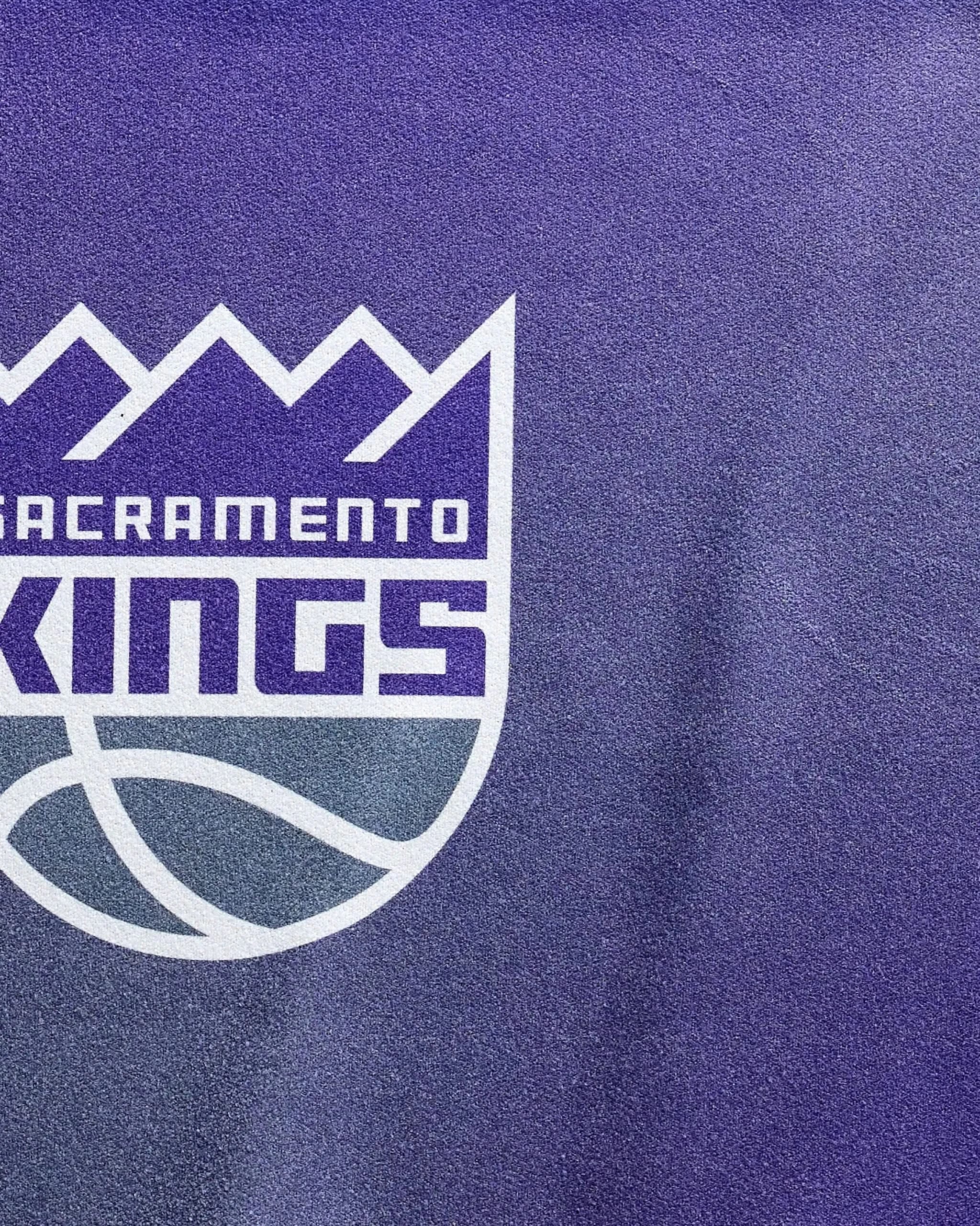 The Kings Fade fitness towel by NBALAB x Geometry features a stylized Sacramento Kings logo on textured purple quick-drying, sustainable fabric—ideal for displaying team pride during workouts.