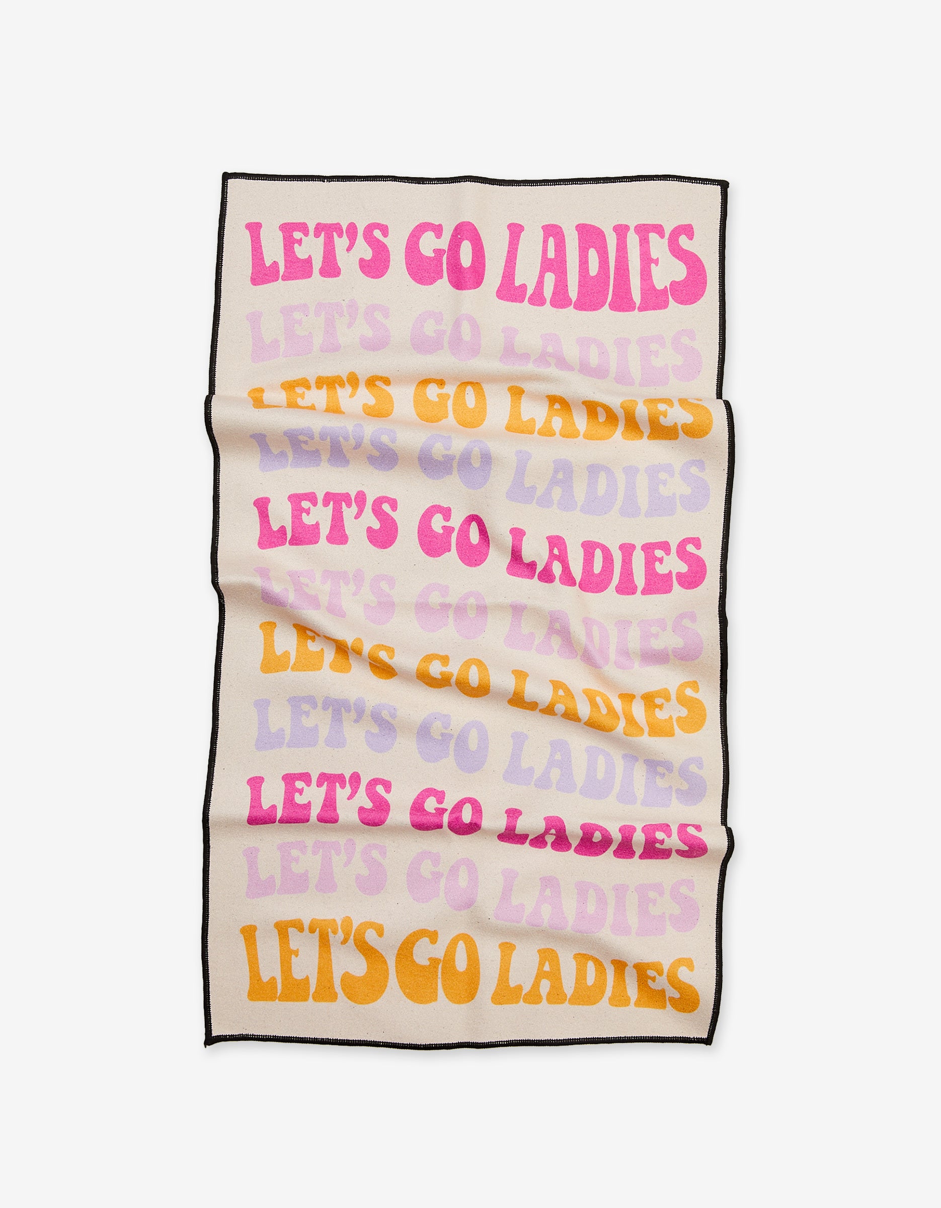The GEOMETRY Ladies Only blanket, made from recycled materials, displays LETS GO LADIES in bold pink, purple, orange, and yellow letters on a cream background with visible folds and wrinkles.