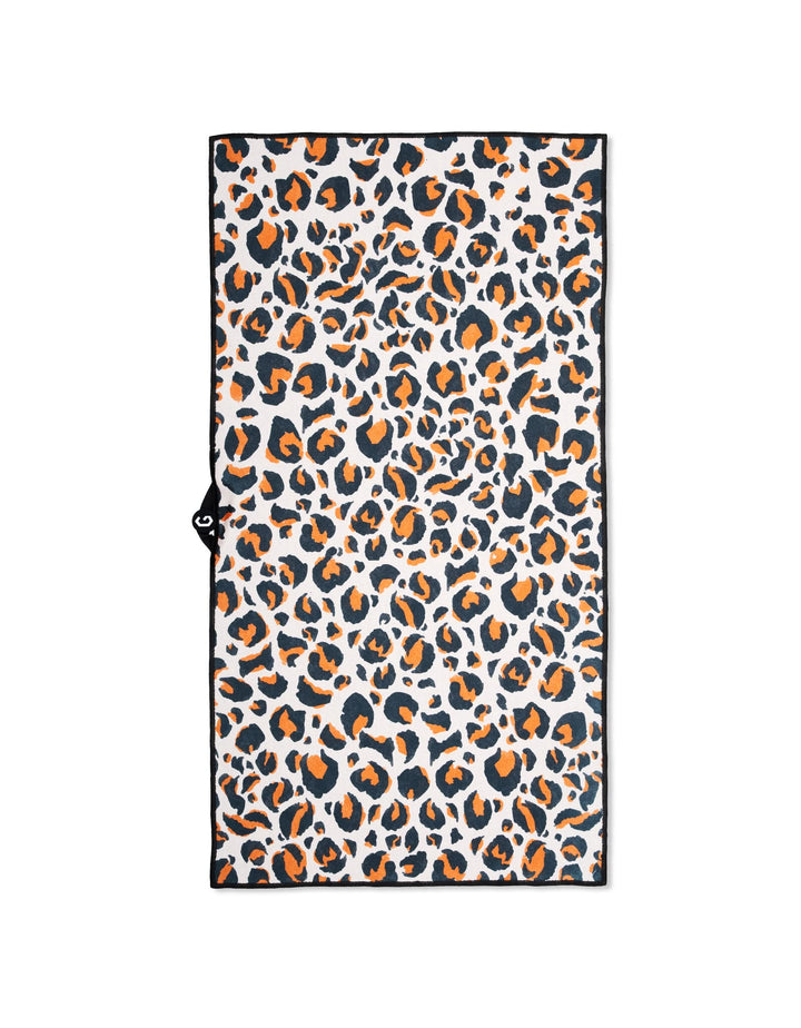 The Magna - Leopard fitness towel by GEOMETRY features a black, orange, and beige leopard print on white with a thin black border. Ultra-absorbent and ideal for gym sessions.