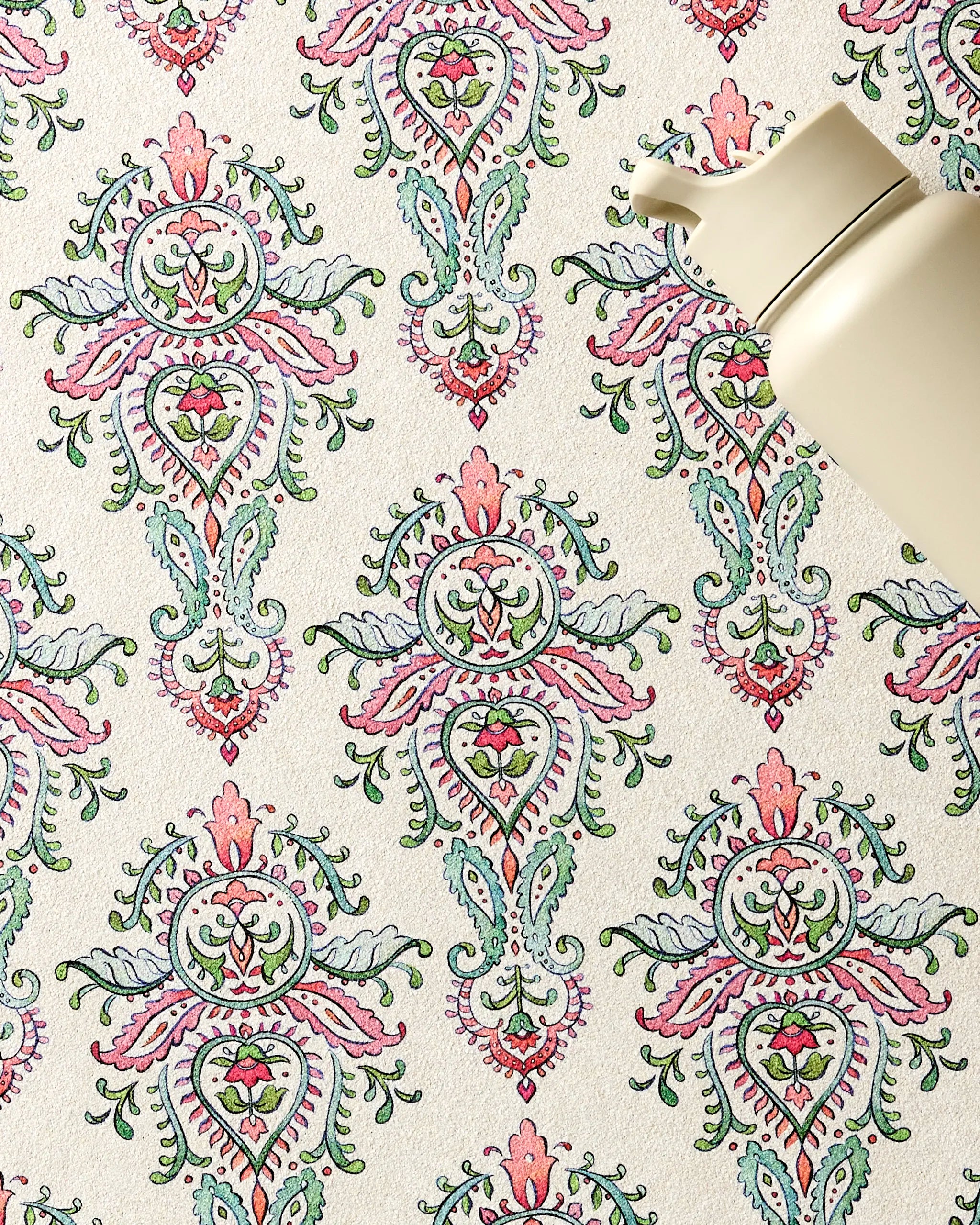 The Memento reusable water bottle by Maayan Alper-Swan rests on a vibrant floral surface in pink, green, and blue, paired with an ultra-absorbent fitness towel for added convenience.