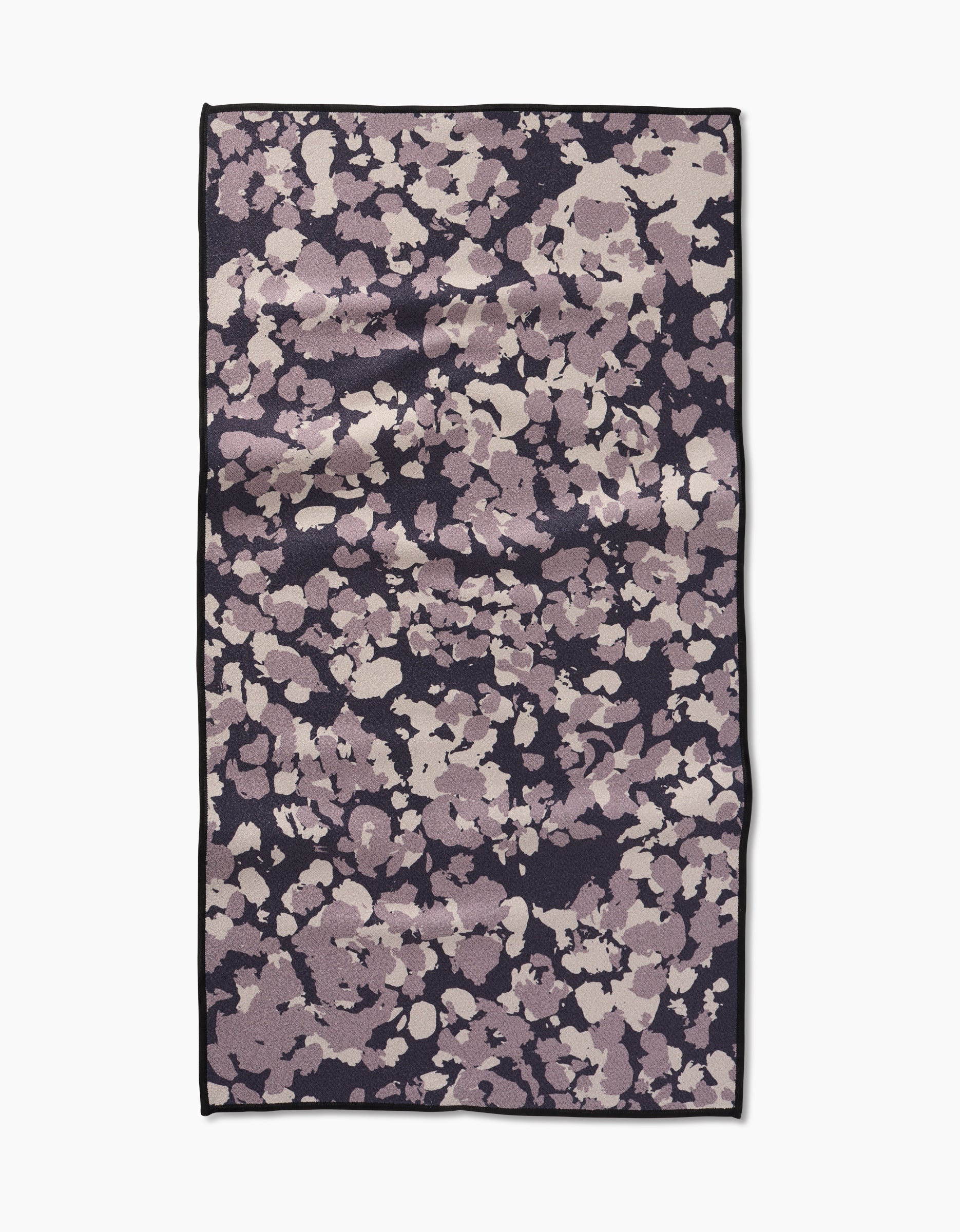 The GEOMETRY Metro Mesh is a rectangular fitness towel with an abstract lavender, mauve, and cream pattern on a dark background, bordered in black—crafted from ultra-absorbent recycled materials.