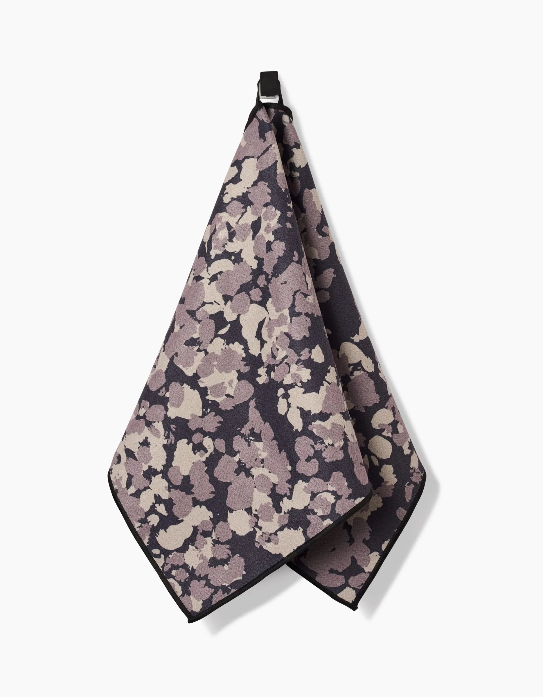 The GEOMETRY Metro Mesh Fitness Towel, crafted from recycled materials, features a floral abstract pattern in purple, beige, and taupe with a black hook and hangs against a white background.