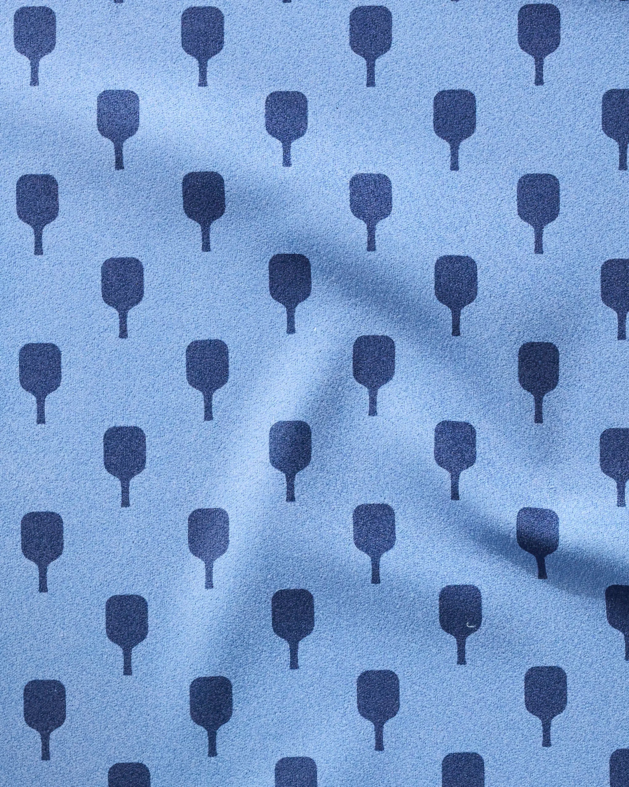 The Modern Dad’s “Pickle Ball Anyone” towel is light blue with a repeating dark blue paddle pattern, evenly spaced in rows and columns. Slight wrinkles add texture to this ultra-absorbent, eye-catching fitness accessory.