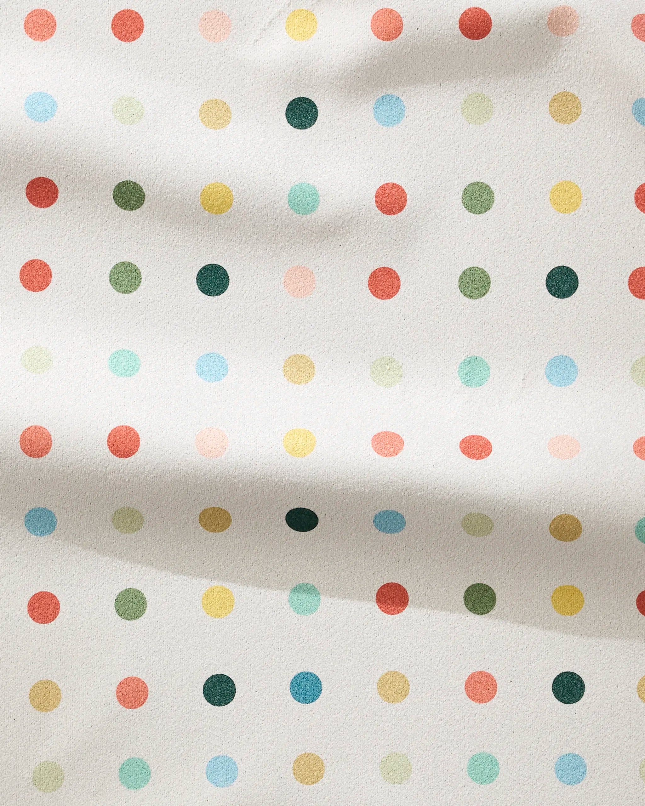 The Elizabeth Edwards Retro Dot is a white fitness towel made from recycled materials, with ultra-absorbent fabric and multicolored red, yellow, green, and blue polka dots in an even pattern.
