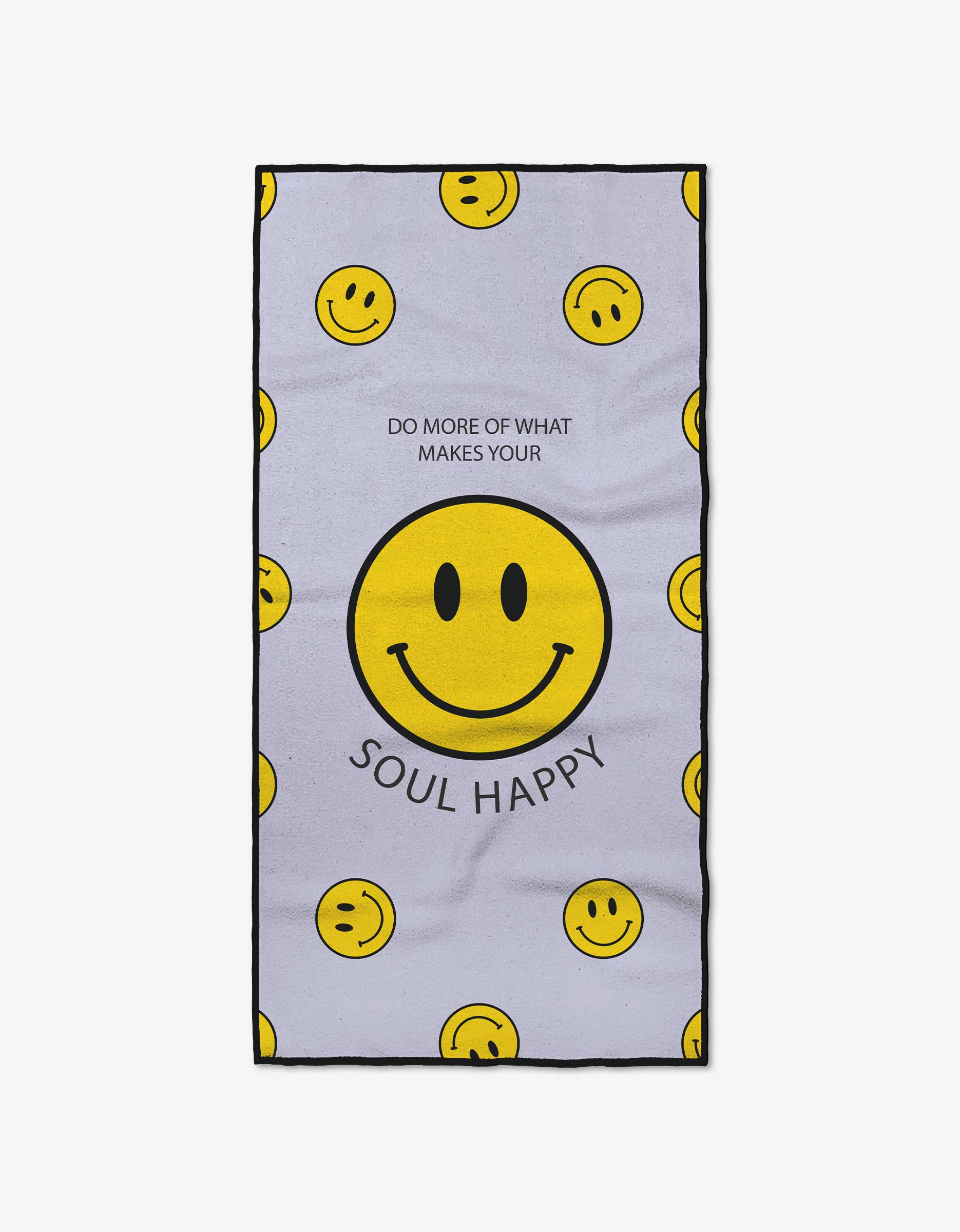 The Quotes by Christie Soul Happy towel is light purple with scattered yellow smiley faces, made from ultra-absorbent recycled materials. A large center smiley face is encircled by “DO MORE OF WHAT MAKES YOUR SOUL HAPPY.”.