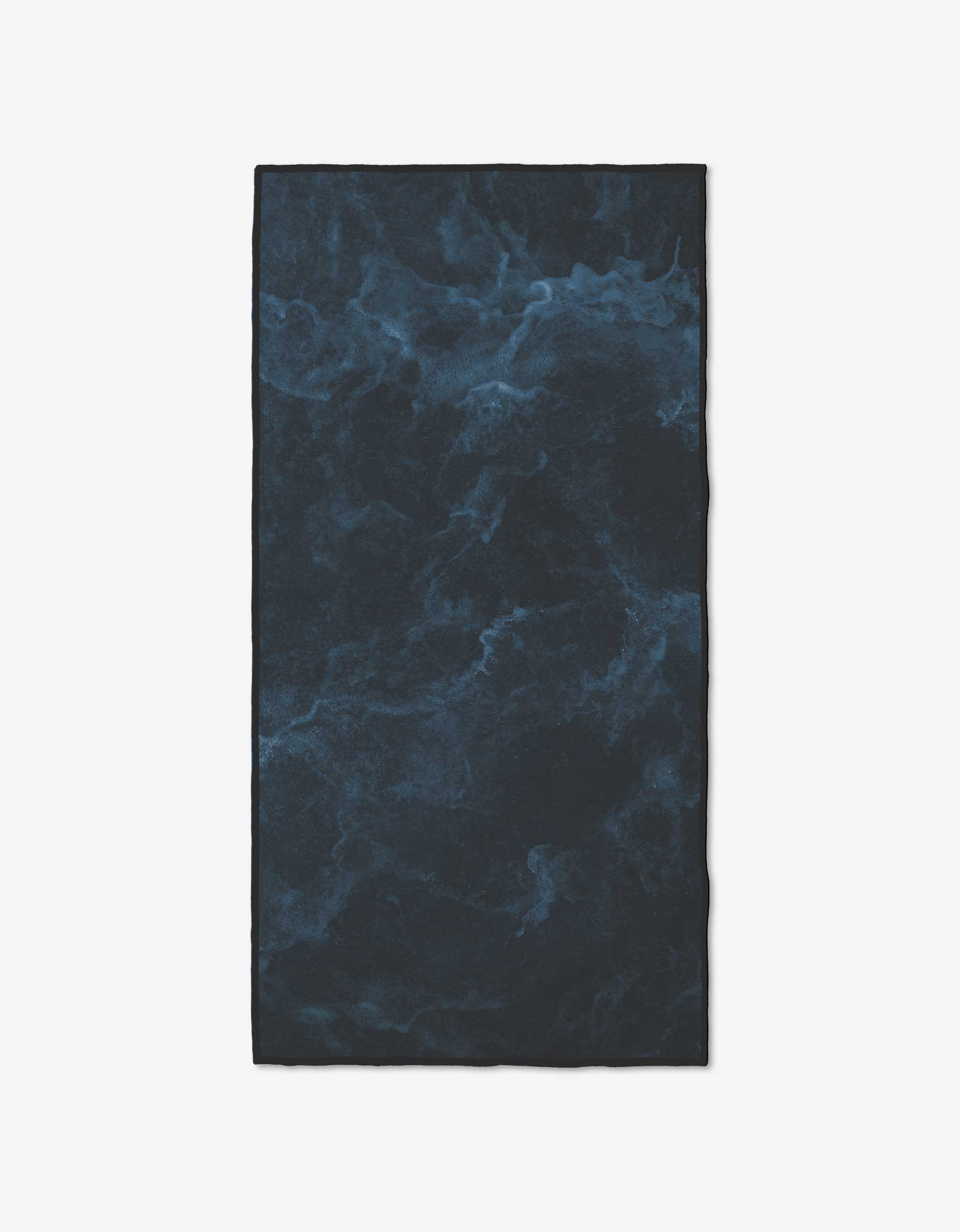 The GEOMETRY Stormshade is a rectangular fitness towel featuring a dark blue and black marbled design, inspired by swirling water. Made from ultra-absorbent recycled materials, it delivers eco-friendly performance.