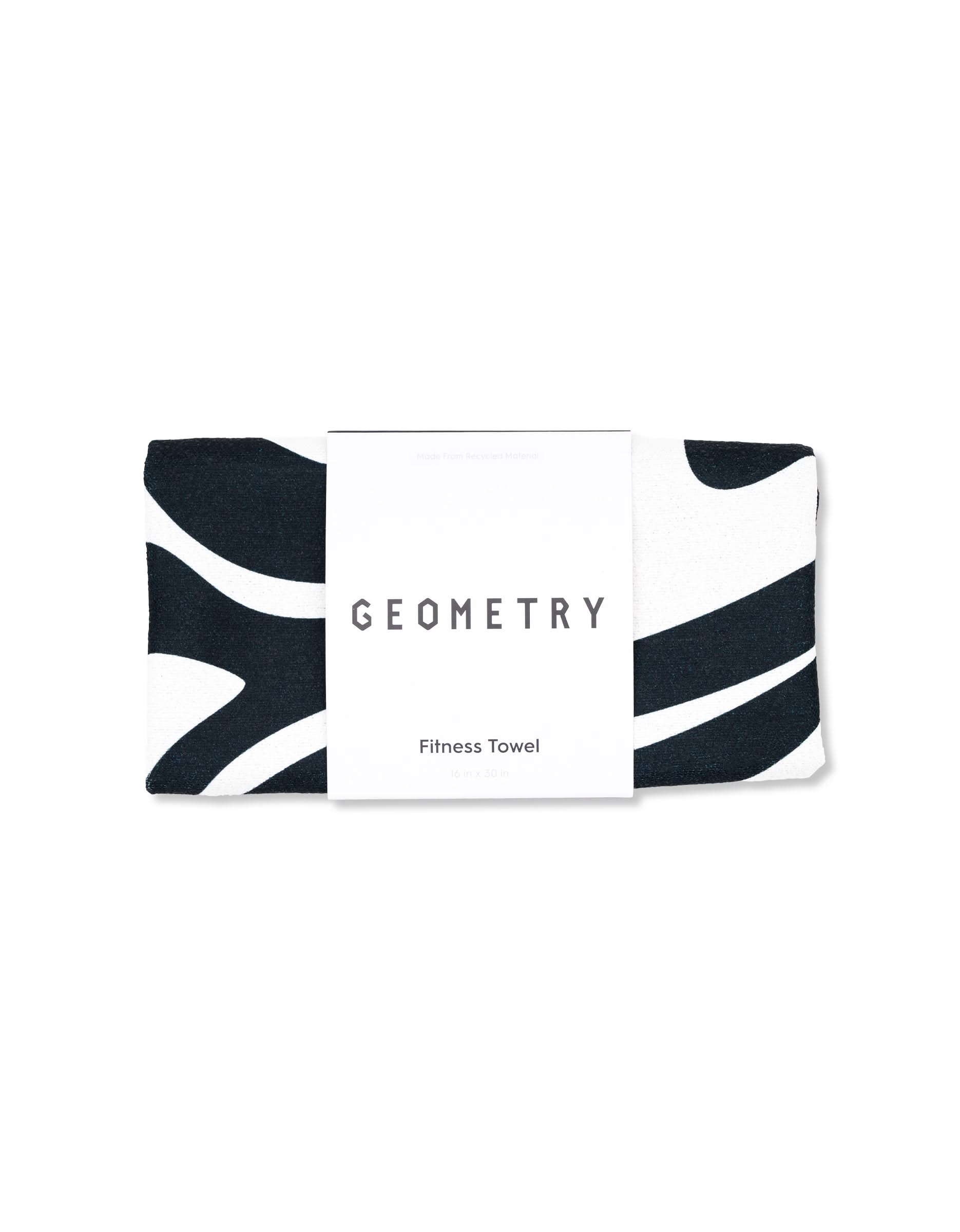 A folded GEOMETRY fitness towel named Magna - Swirls featuring a black and white pattern and ultra-absorbent material, with a label reading GEOMETRY Fitness Towel.