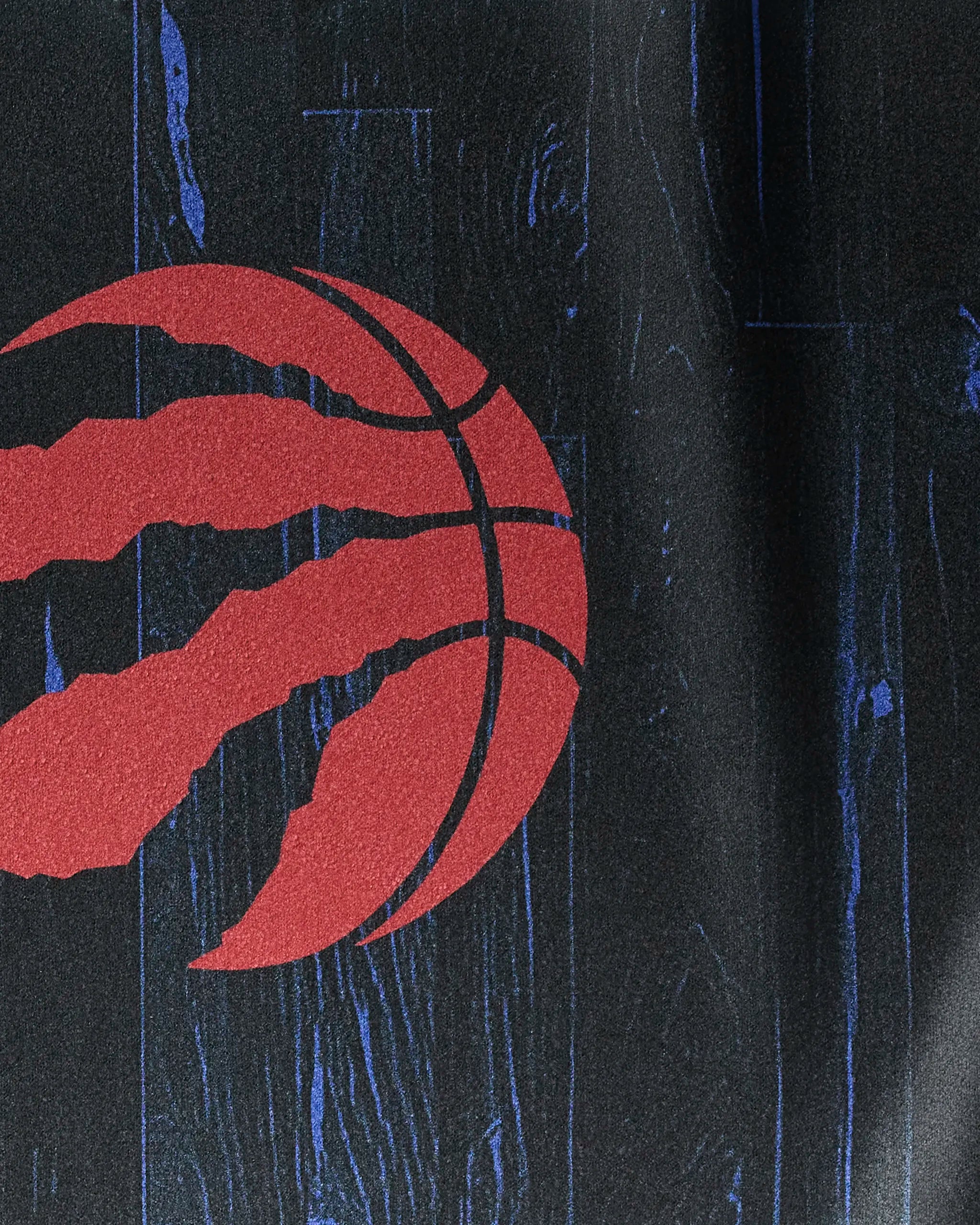 The Raptors Zone NBA fitness towel by NBALAB x Geometry features a red basketball marked with three raptor claw slashes on a dark, textured background accented with blue streaks—a bold courtside statement.