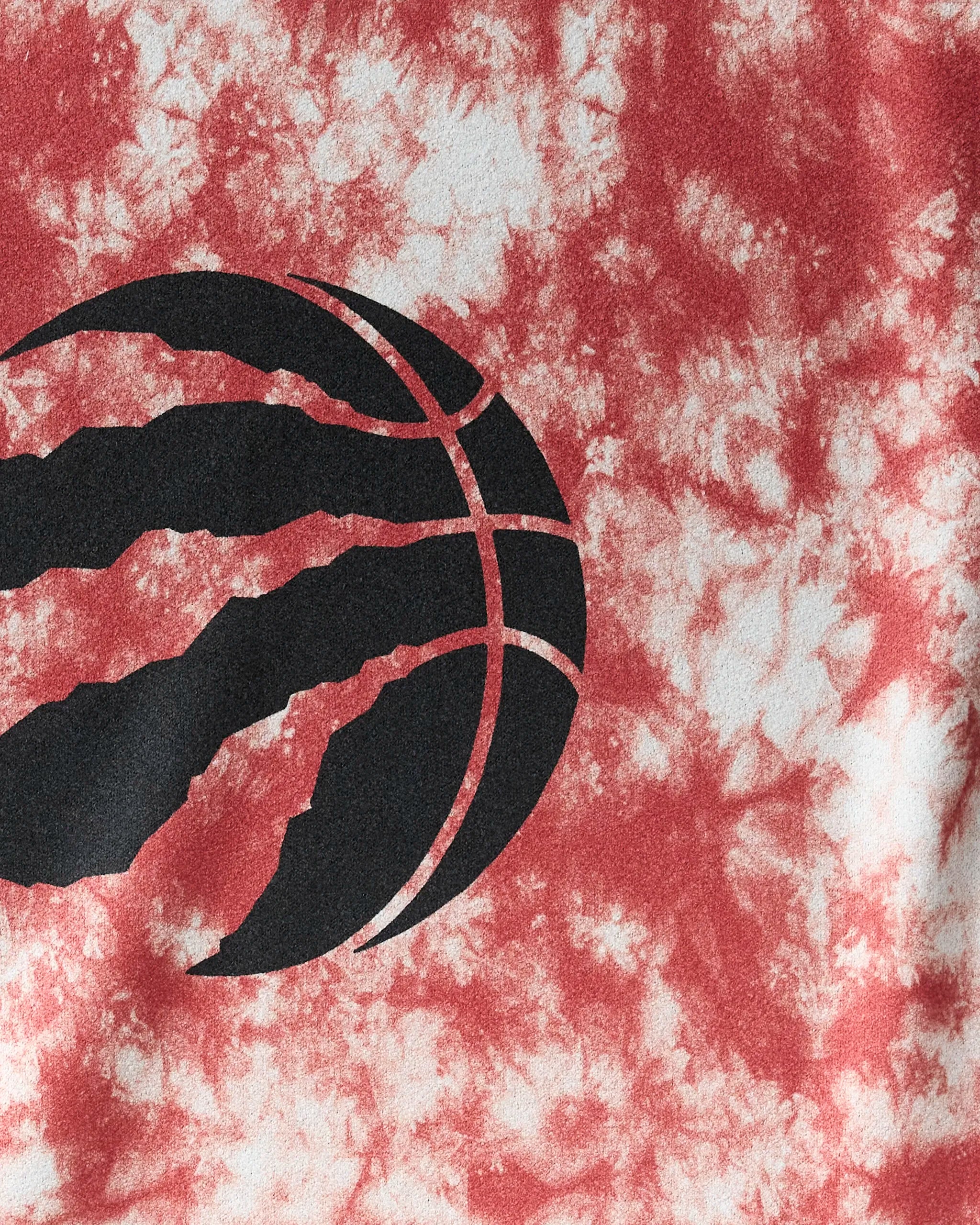 The Raptors Flash gym towel by NBALAB x Geometry features a black basketball graphic with claw marks on a red and white tie-dye background, offering quick-drying performance ideal for active lifestyles.
