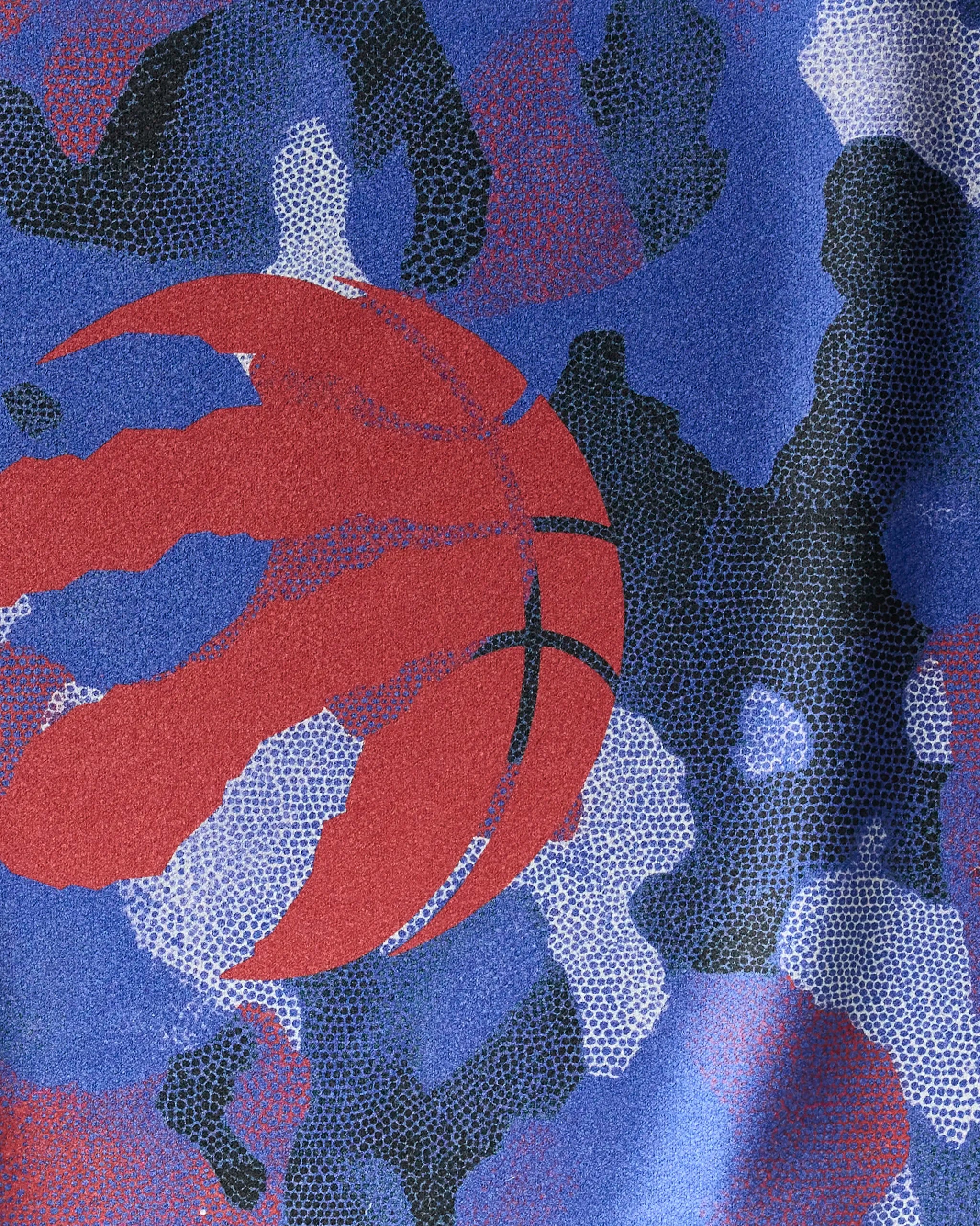 The Raptors Camo by NBALAB x Geometry features a red basketball claw logo centered on a blue, black, and purple camo pattern with a dotted texture—blending bold style and performance for the ultimate NBA fitness towel.