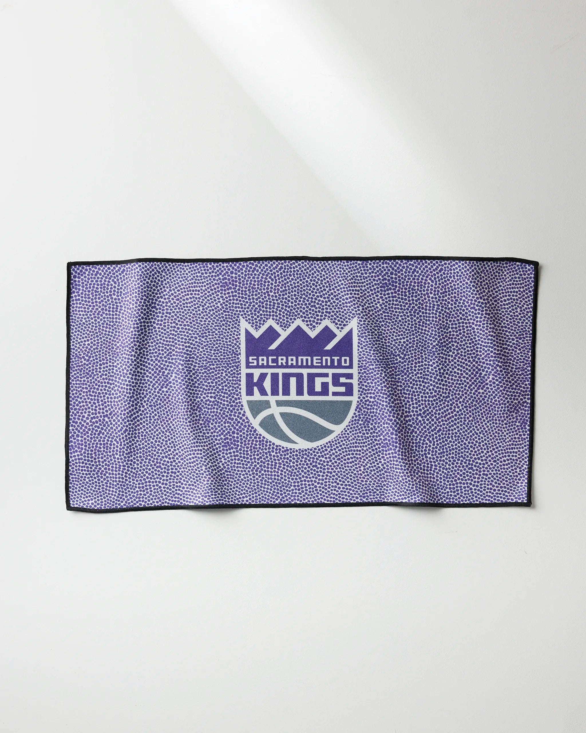 The NBALAB x Geometry Kings Grip is a quick-drying purple gym towel with a black border and Sacramento Kings logo—ideal for NBA fans wanting a functional and stylish accessory.