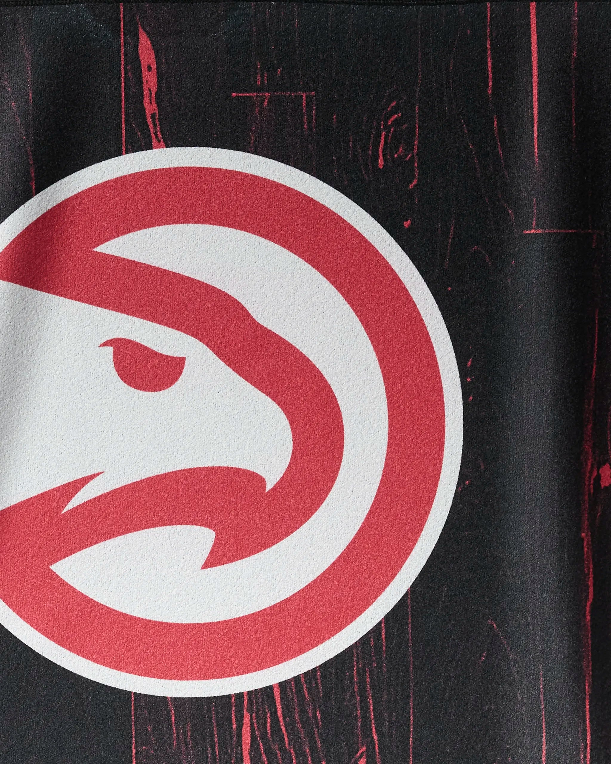A close-up of the Atlanta Hawks logo from the "Hawks Zone" NBALAB x Geometry towel—a stylish, sustainable workout must-have for NBA fans.