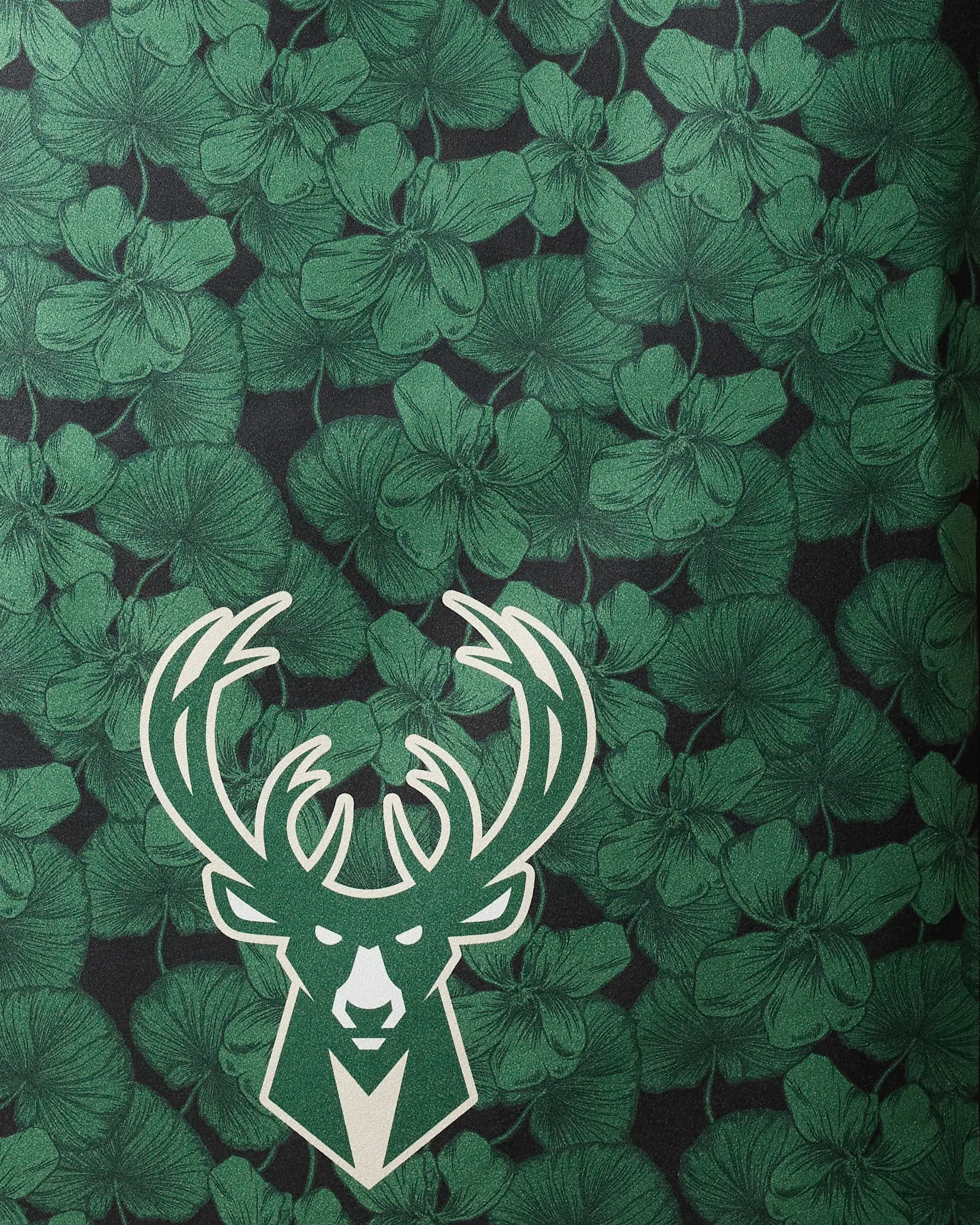 The Bucks Floral NBA beach towel by NBALAB x Geometry features a stylized white deer head on a dark green floral background and is made from recycled materials.