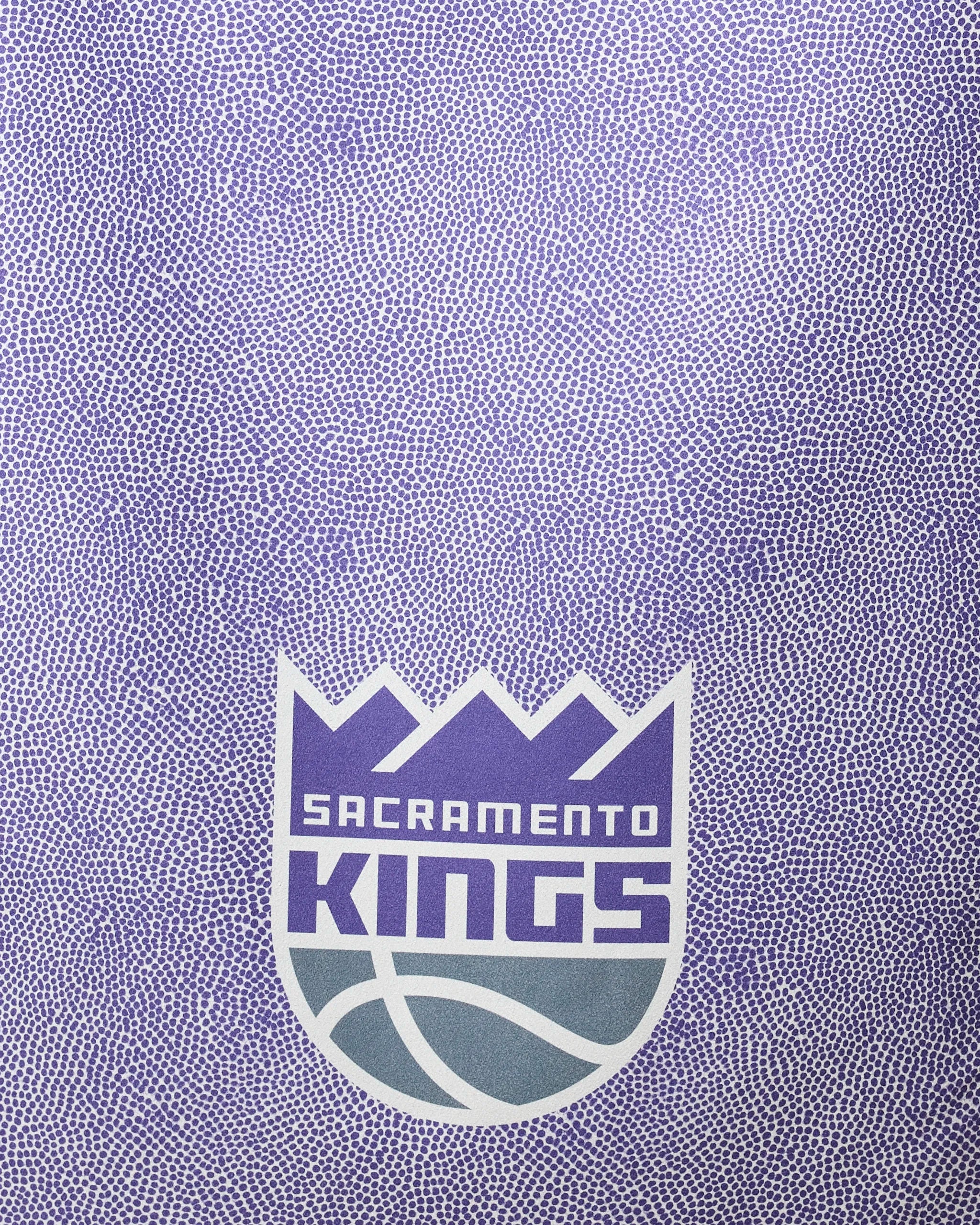 The image features the Sacramento Kings logo on a textured purple background, inspired by a basketball, ideal for the Kings Grip beach towel by NBALAB x Geometry—crafted with quick-drying, recycled materials.