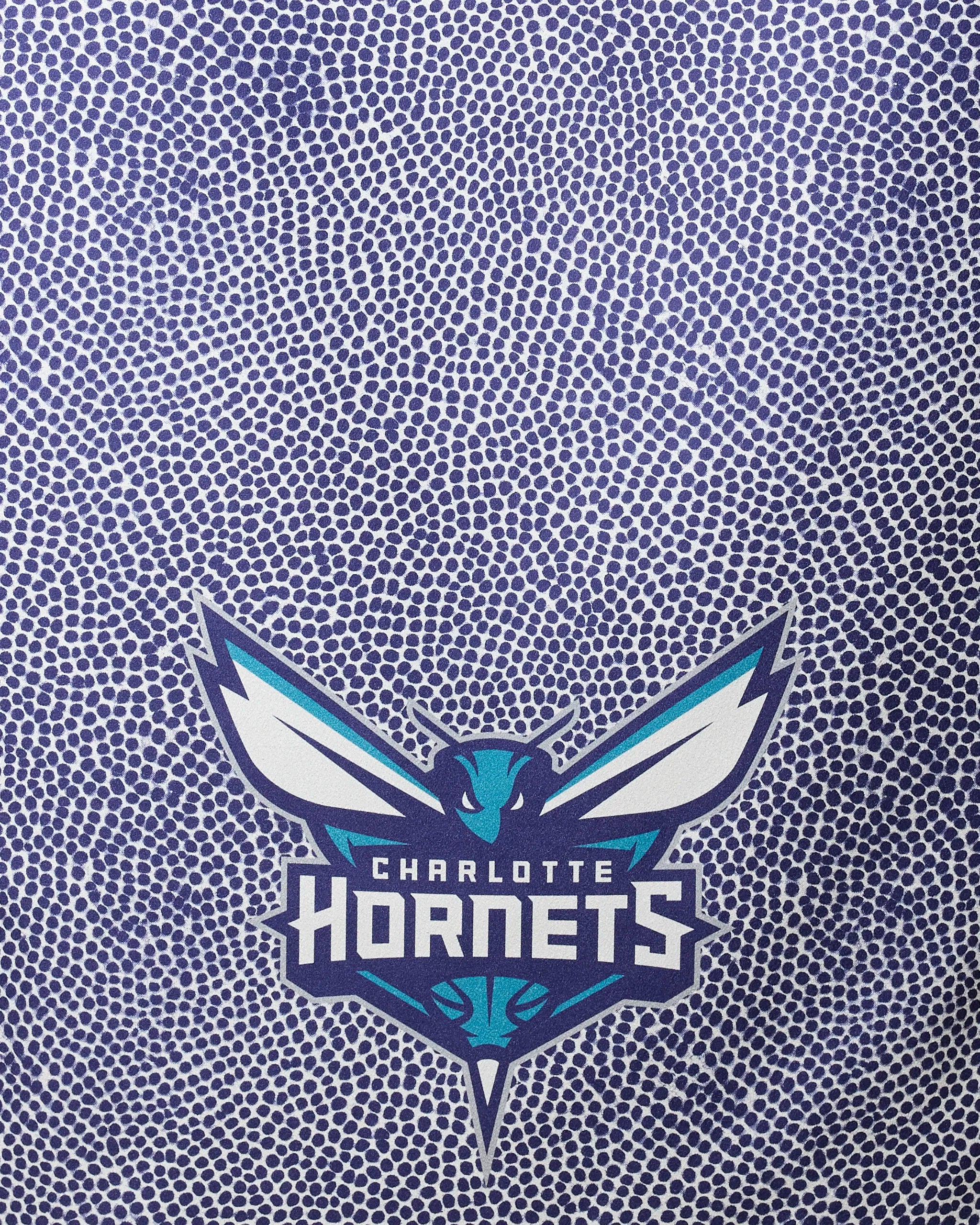 The Hornets Grip by NBALAB x Geometry features a stylized teal and white hornet with outstretched wings on a quick-drying, recycled NBA beach towel with a textured blue and white dotted pattern.