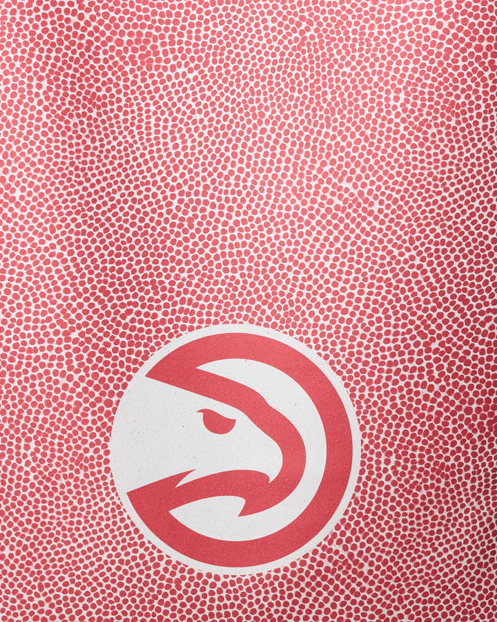 The NBALAB x Geometry Hawks Grip beach towel features a red and white dotted background with a stylized red hawk head logo in a circle near the bottom center—delivering quick-drying comfort and standout NBA style.