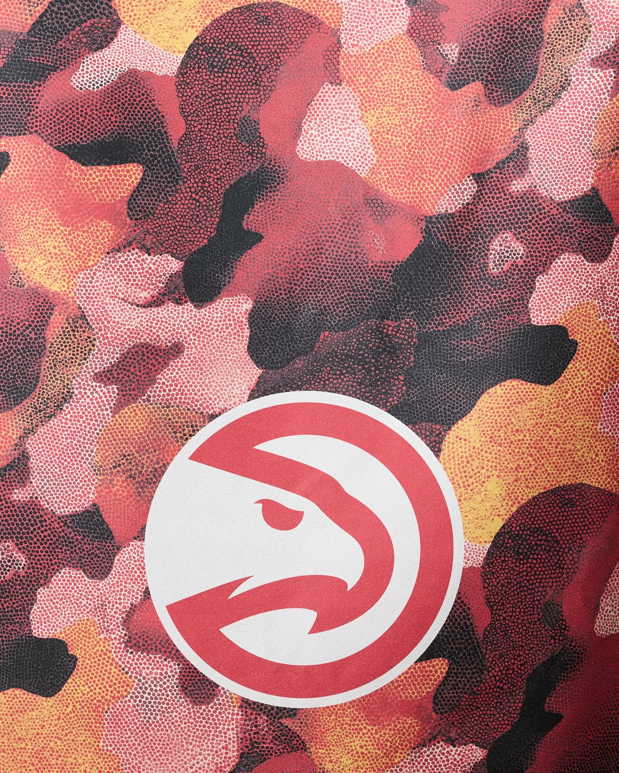 The Hawks Camo beach towel by NBALAB x Geometry features a red and black camouflage pattern with a white circle and logo, made from quick-drying material.