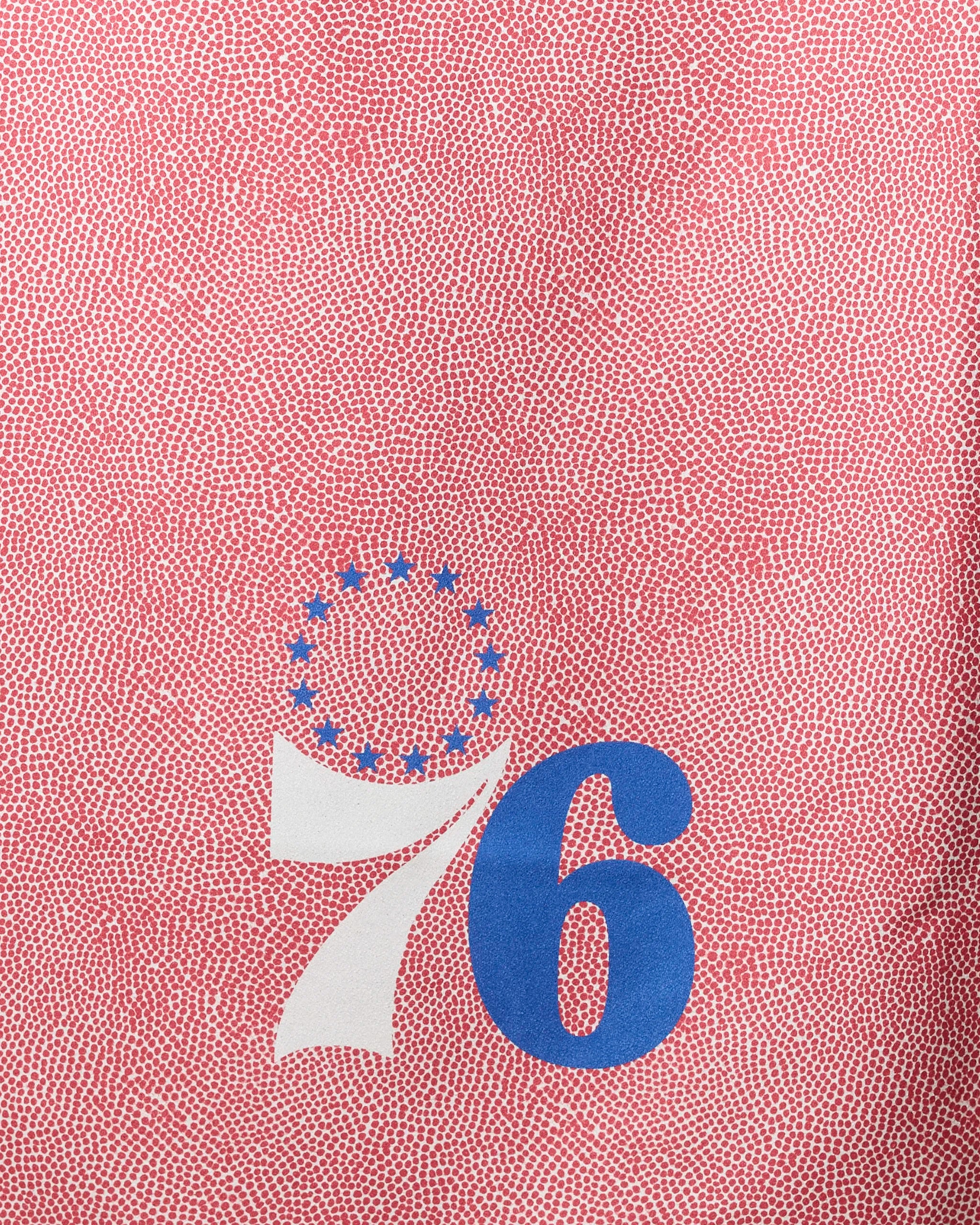 The NBALAB x Geometry 76ers Grip beach towel showcases a red textured background, bold white 7 and blue 6 forming "76," and thirteen blue stars above—an eye-catching, patriotic piece perfect for fans and summer outings.
