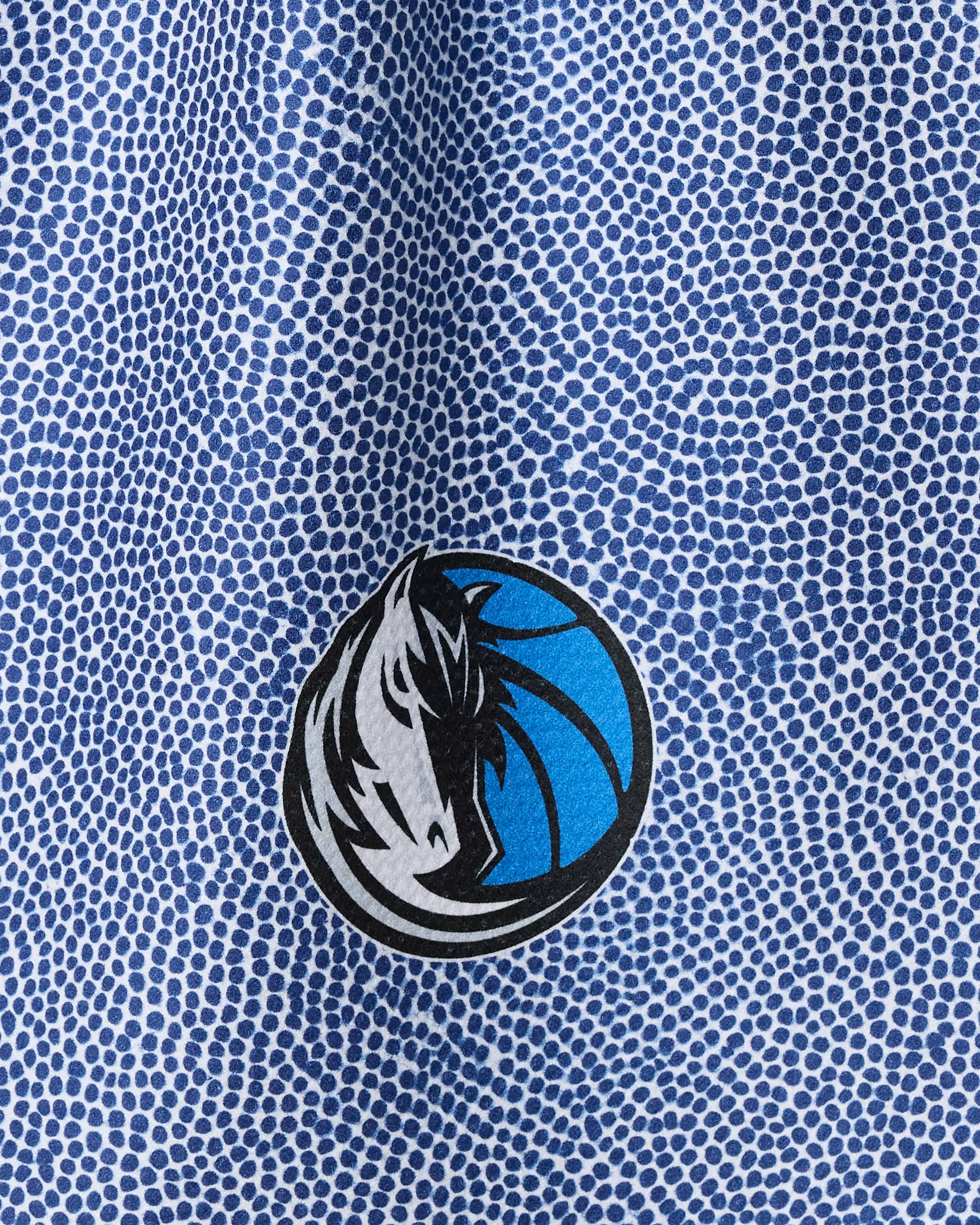 Close-up of the Mavericks Grip tea towel by NBALAB x Geometry, featuring a blue and white dotted design and Dallas Mavericks logo. This recycled kitchen towel is perfect for NBA fans eager to show team pride.