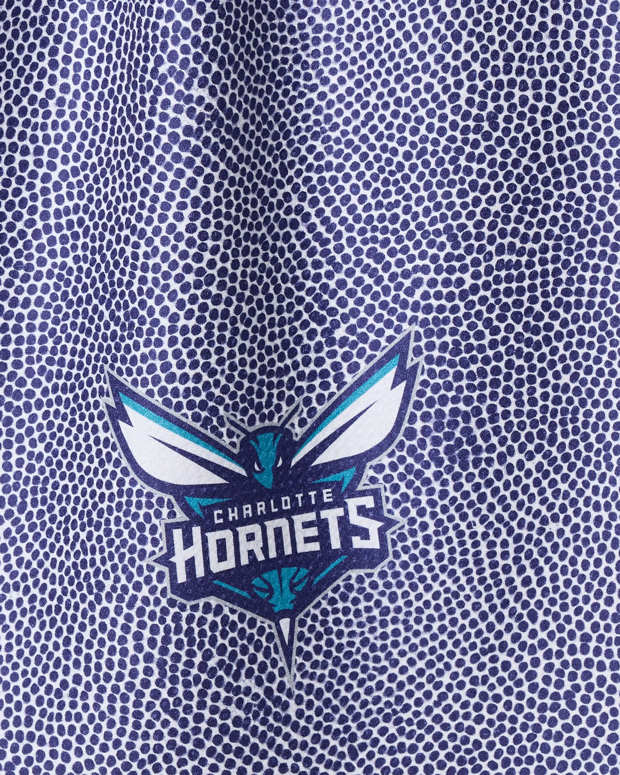 Close-up of Hornets Grip by NBALAB x Geometry—a purple, basketball-textured towel featuring the Charlotte Hornets logo. This officially licensed NBA accessory is perfect for dedicated fans.