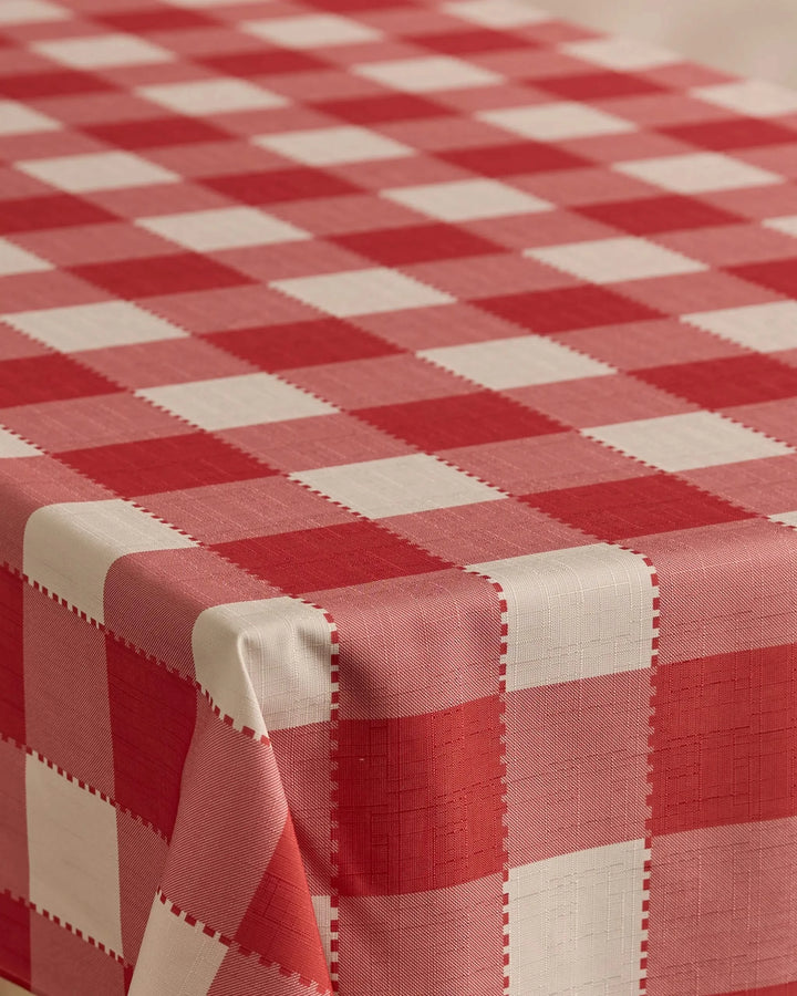 A close-up of Geometry’s Ripe Tomato Gingham rectangular tablecloth, featuring a stain-resistant red and white checkered pattern that highlights the fabric texture and precise alignment along the edges and corners.
