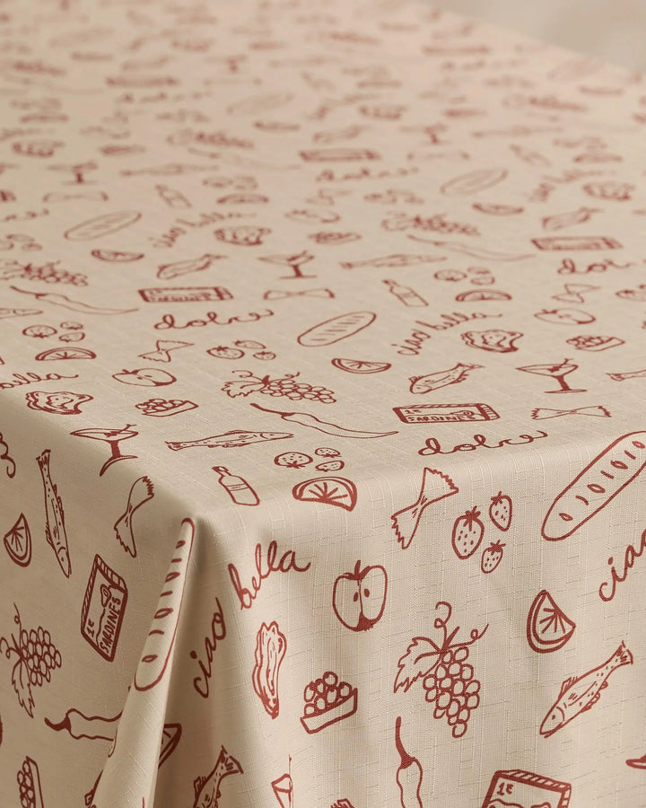 The Geometry Summer Air tablecloth features a beige, stain-resistant design with red line art of Italian foods and handwritten phrases like ciao bella. Made from recycled materials, its ideal for any kitchen or dining space.