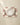 A white plate sits on the Geometry Horse Check Cream placemat with maroon horse designs, flanked by a fork and knife on a beige tablecloth. These machine-washable placemats blend style and easy care for any setting.