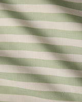 Seagrass by Geometry features light green and white horizontal stripes on textured, recycled tablecloth fabric, with soft waves and shadows adding gentle movement and depth.