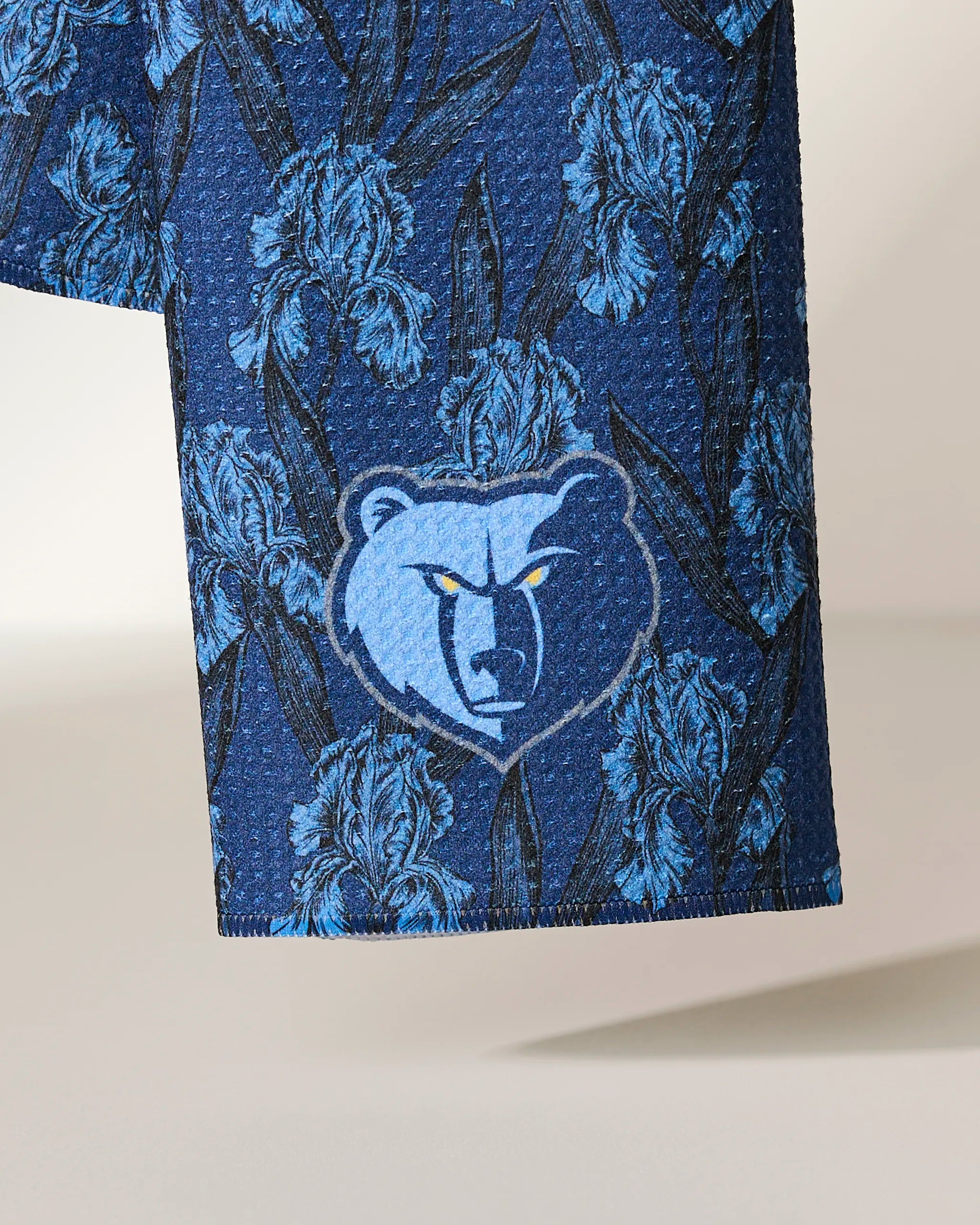 Close-up of the Geometry Grizzlies Floral fabric, featuring a blue floral pattern with the Memphis Grizzlies bear logo in the center.