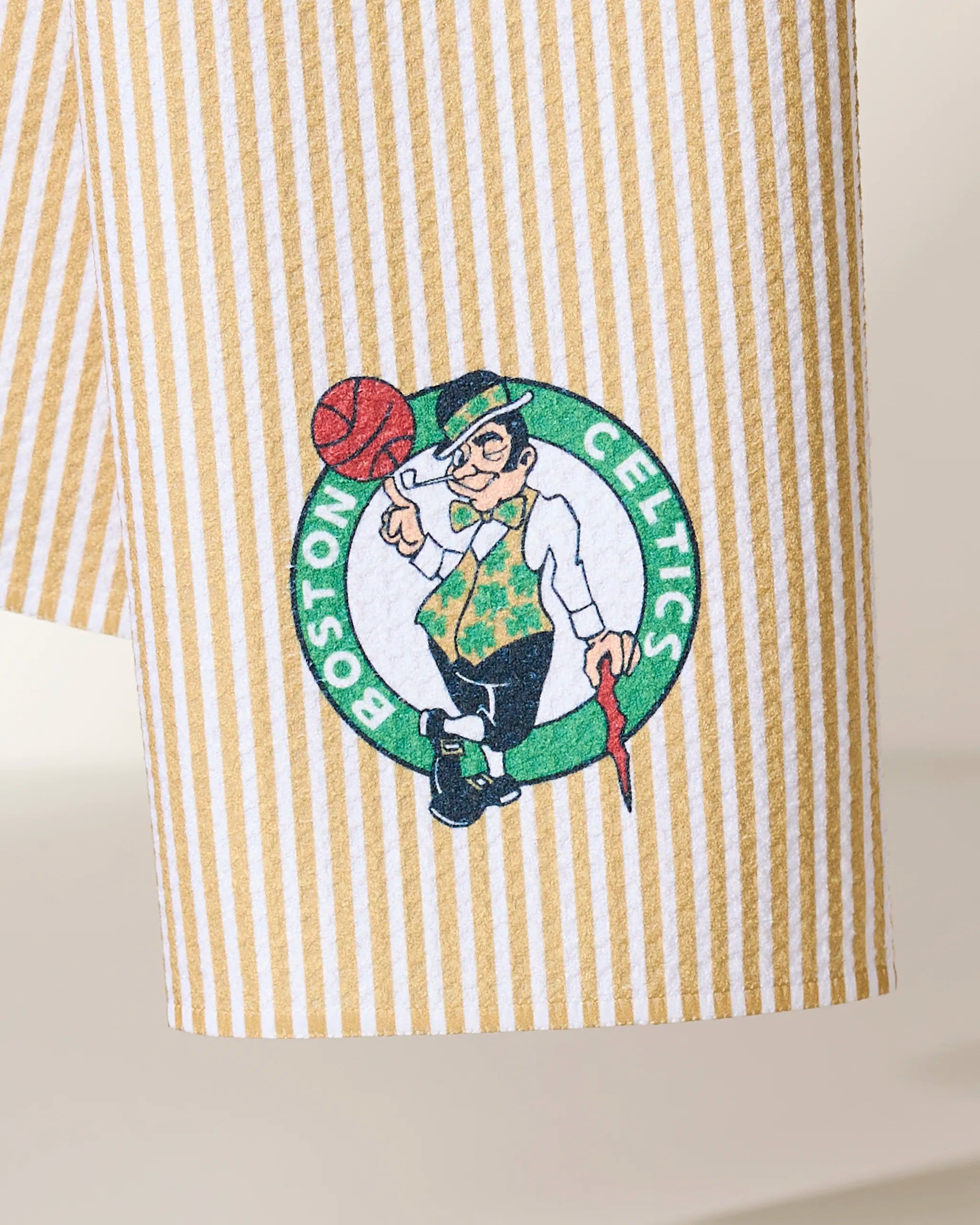 The Geometry Celtics Classic fabric is yellow and white striped and features the Boston Celtics logo—a leprechaun spinning a basketball, leaning on a cane, and wearing a clover vest.