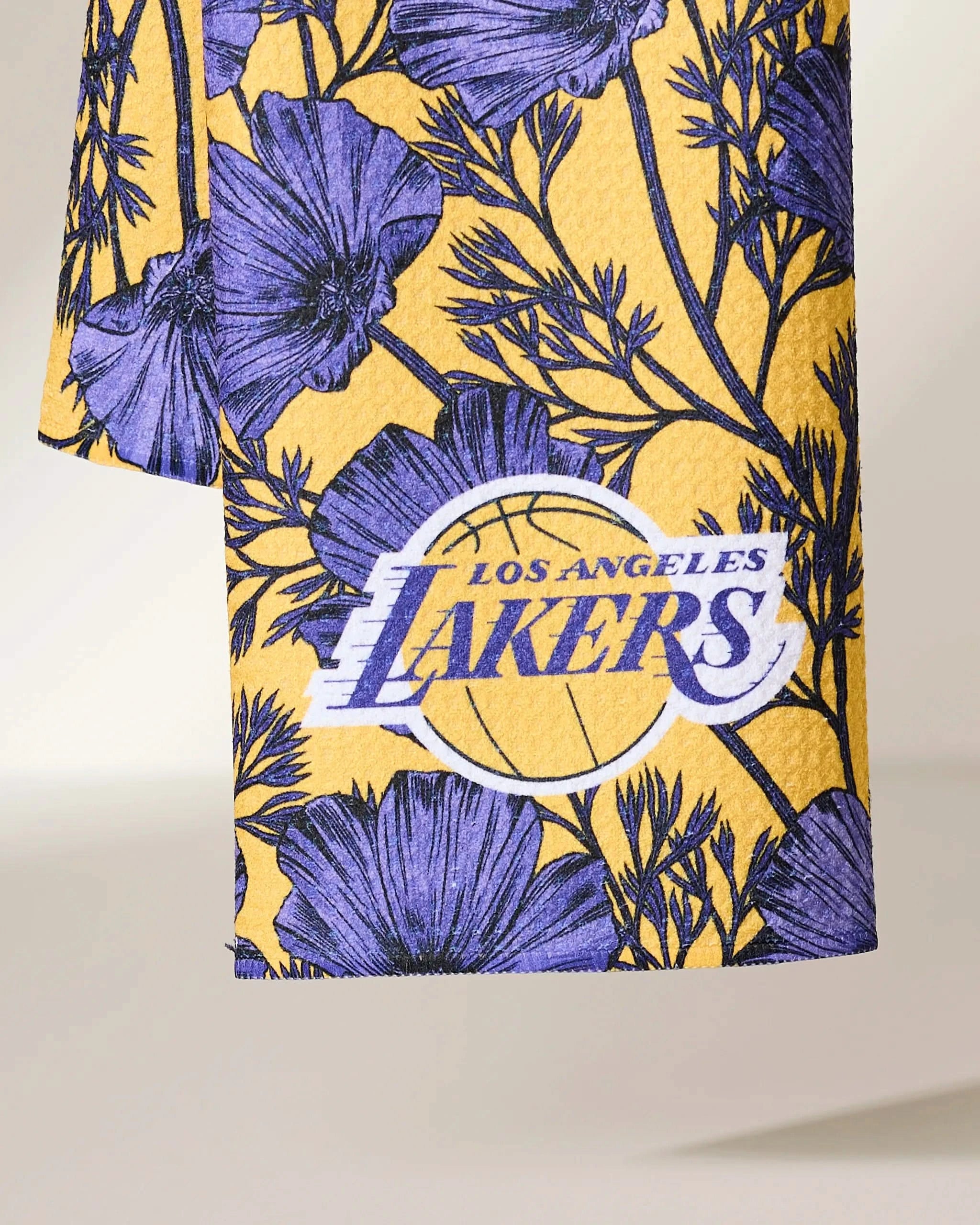 The Geometry Lakers Floral features a yellow fabric with an intricate purple floral pattern and the Los Angeles Lakers logo—a basketball with bold white text—prominently centered.