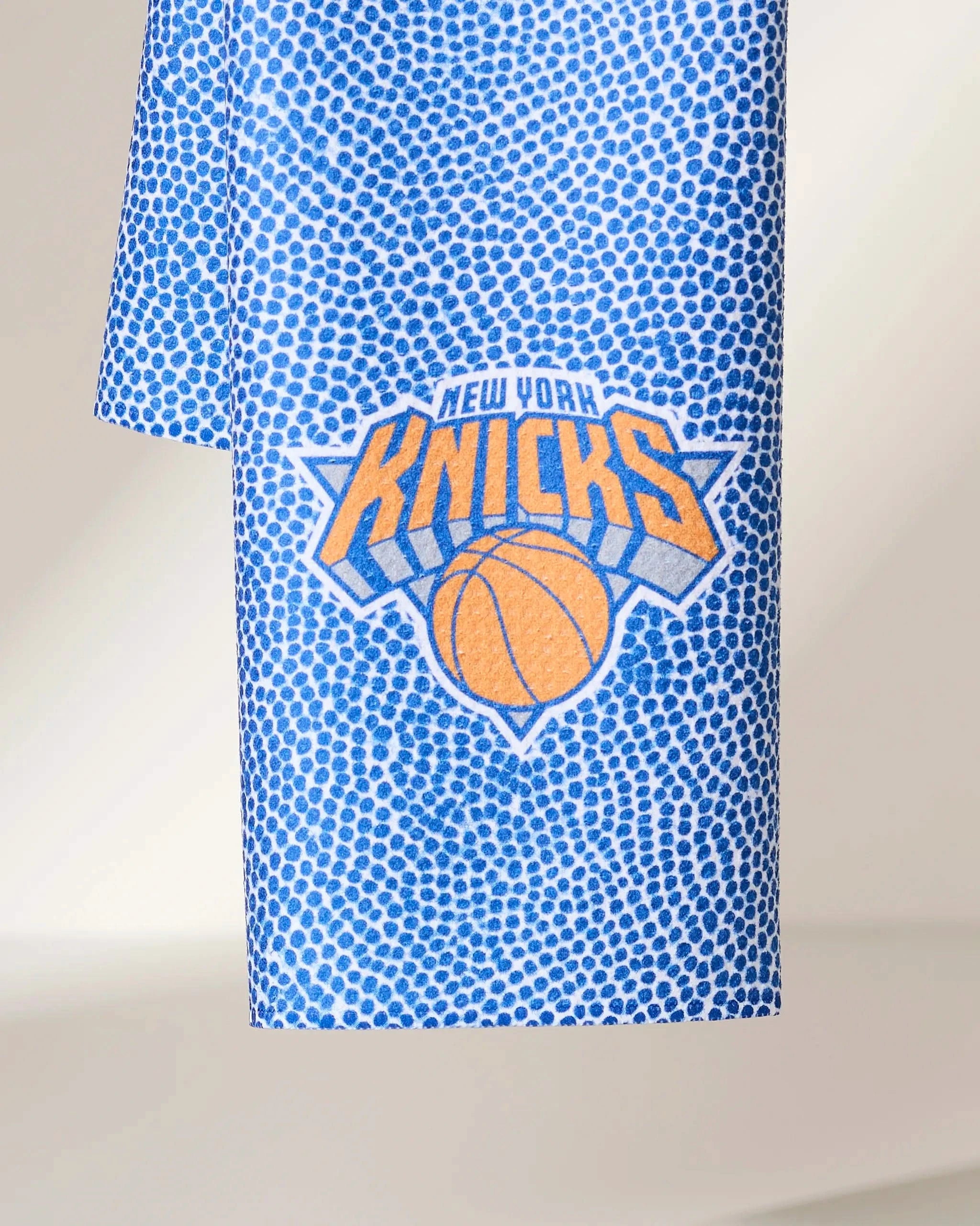 The Geometry Knicks Grip is a blue and white polka dot towel featuring the New York Knicks logo in orange, blue, and white.
