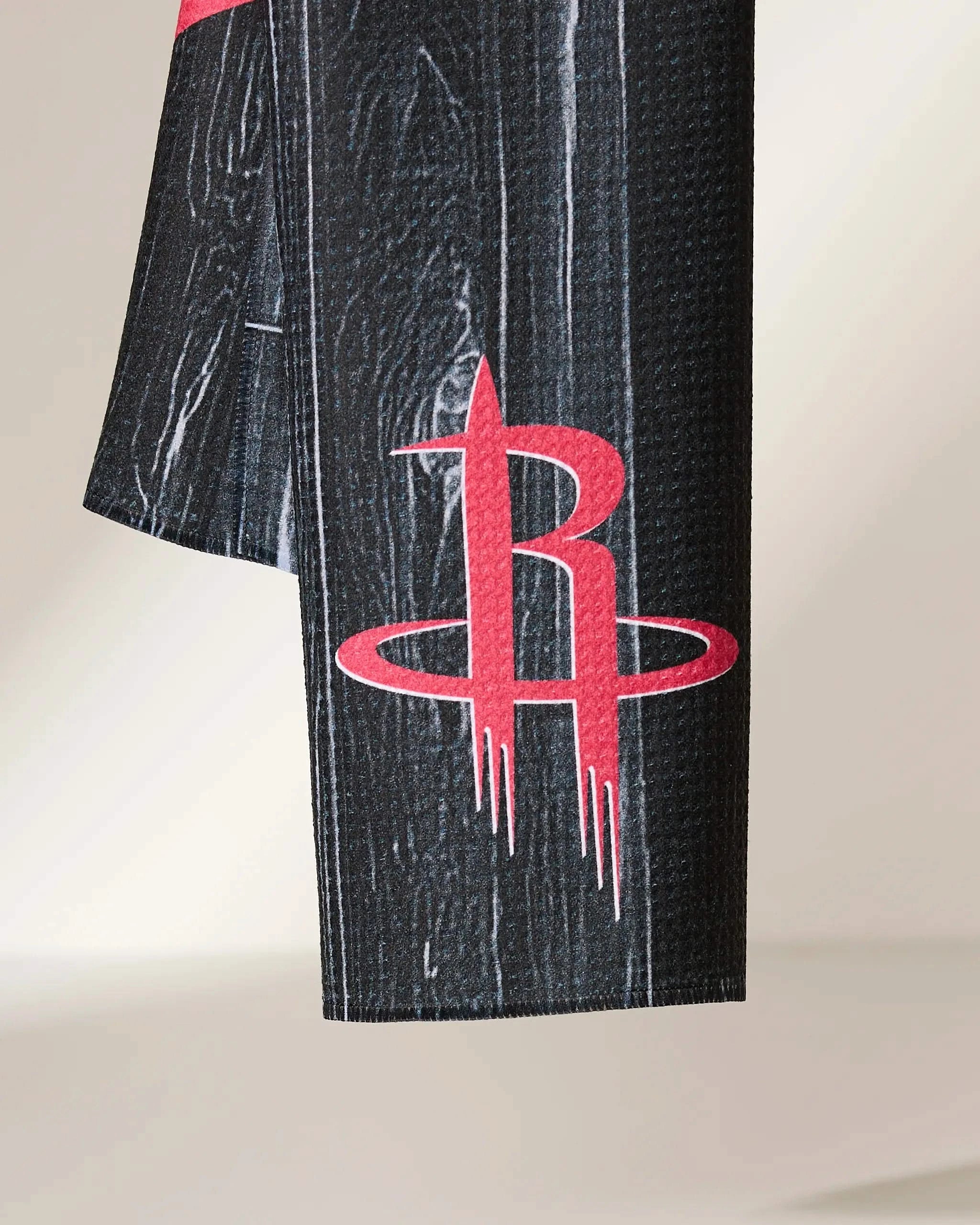A close-up of the Rockets Zone by Geometry, showcasing black textured fabric with a red and white Houston Rockets logo.