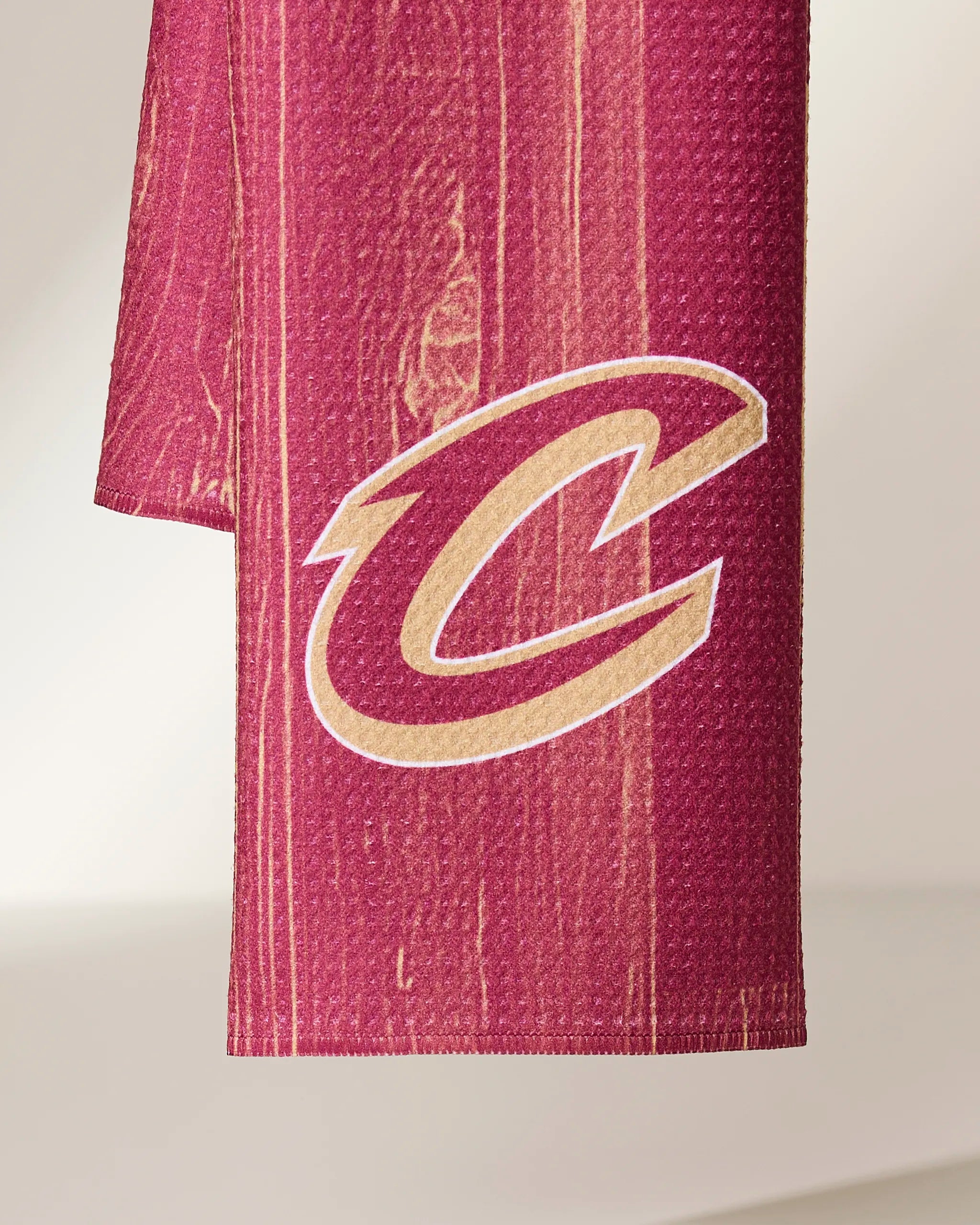 The Cavaliers Zone towel by Geometry features a large gold and white Cleveland Cavaliers C logo on maroon, displayed against a neutral background.