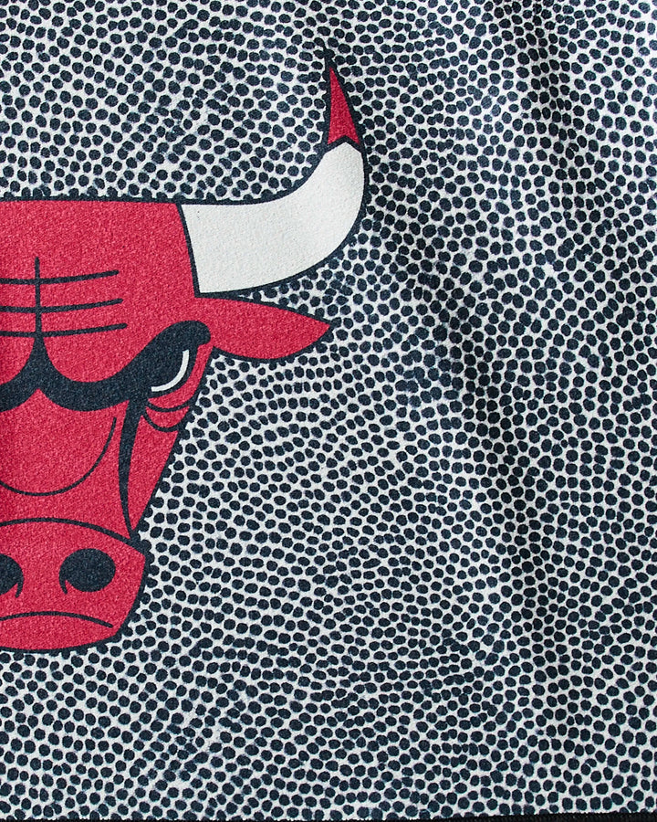 The Bulls Grip by NBALAB x Geometry features a stylized close-up red bull’s face with a white horn on black and white pebbled dots—a sustainable workout towel, ideal for NBA-inspired fitness routines.