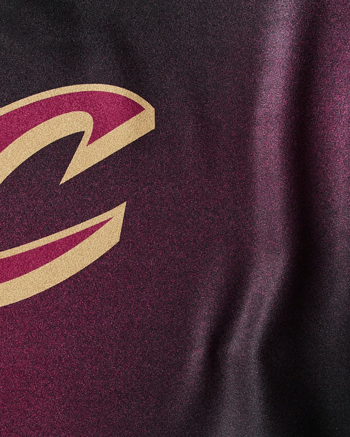 Close-up of the NBALAB x Geometry Cavaliers Fade fitness towel in maroon and black, featuring a partial gold and maroon Cleveland Cavaliers “C” logo—perfect for showcasing team spirit during workouts.