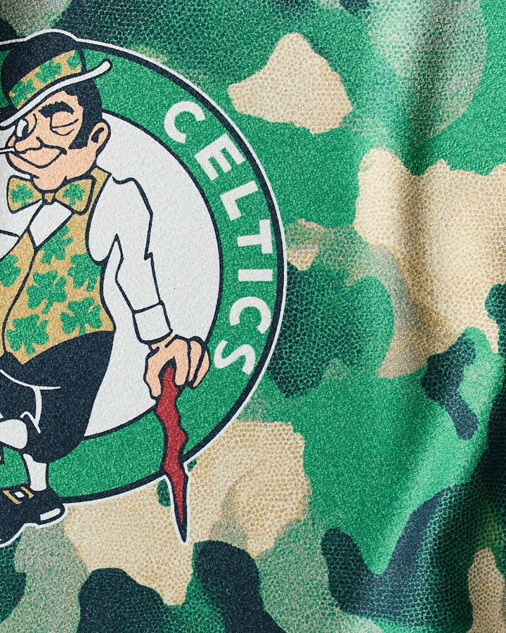 The Celtics Camo towel by NBALAB x Geometry showcases the iconic leprechaun logo over a green and beige camo background—a stylish way to display your Boston Celtics pride during every workout.