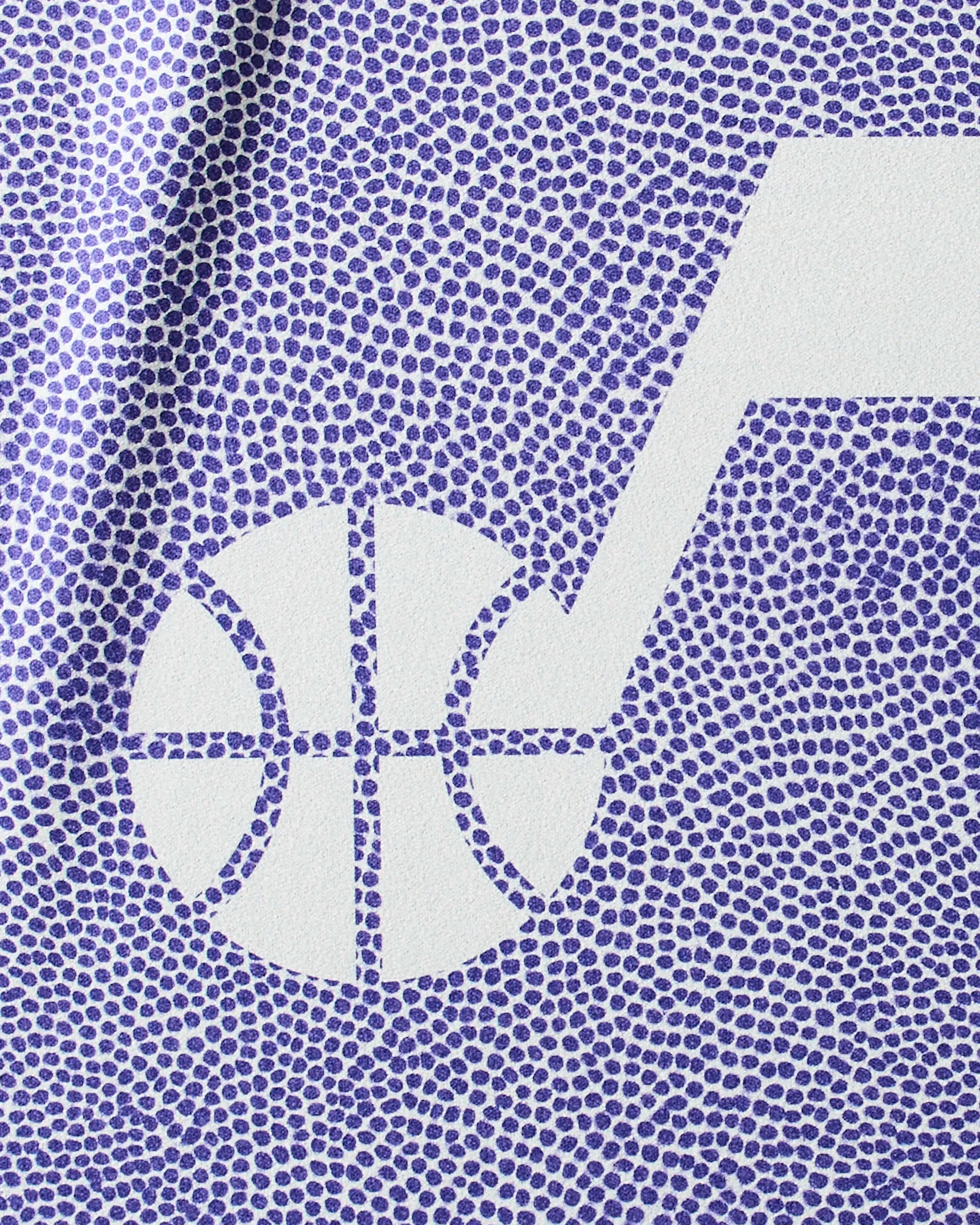 Close-up of the Geometry Jazz Grip fitness towel, featuring a textured pattern of small purple dots and the Utah Jazz logo—a white basketball combined with a stylized musical note.