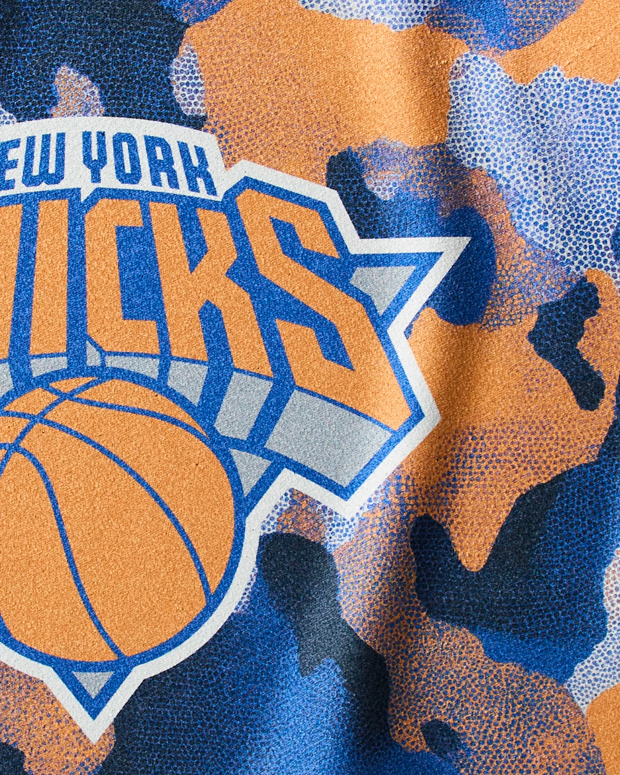 A close-up of the Geometry logo on the Knicks Camo quick-drying gym towel.