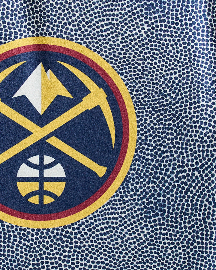 The Nuggets Grip fitness towel by NBALAB x Geometry features the Denver Nuggets logo with a gold pickaxe and mountain above a basketball on a blue and white dotted background, crafted from sustainable Geoweave fabric.