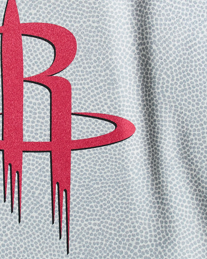 Close-up of the gray Rockets Grip gym towel by NBALAB x Geometry, featuring a subtle dotted pattern and a large red stylized R with an orbit, inspired by the Houston Rockets NBA logo.