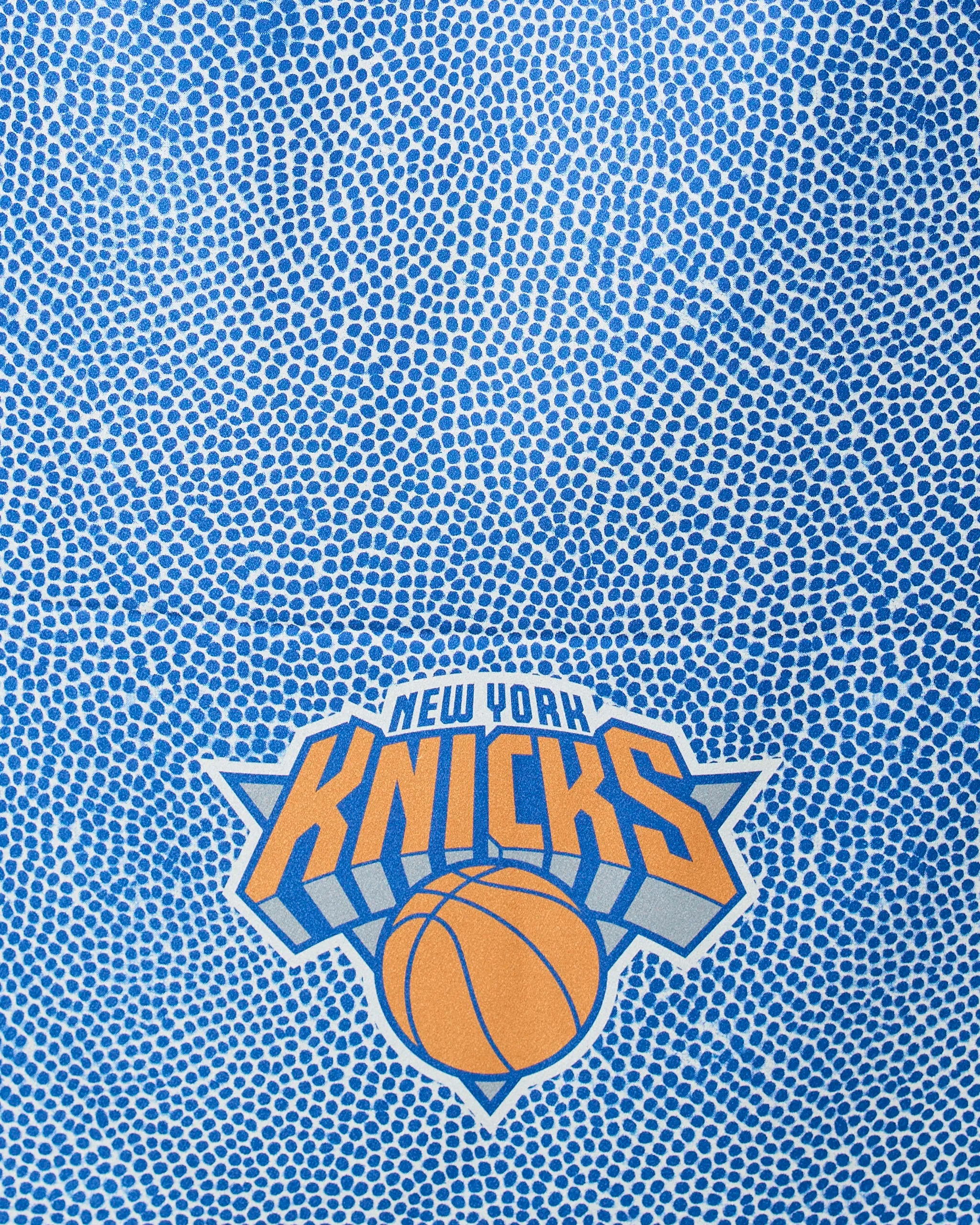 The Knicks Grip by Geometry features the New York Knicks logo and a basketball graphic on a blue, dotted background that mimics basketball texture.