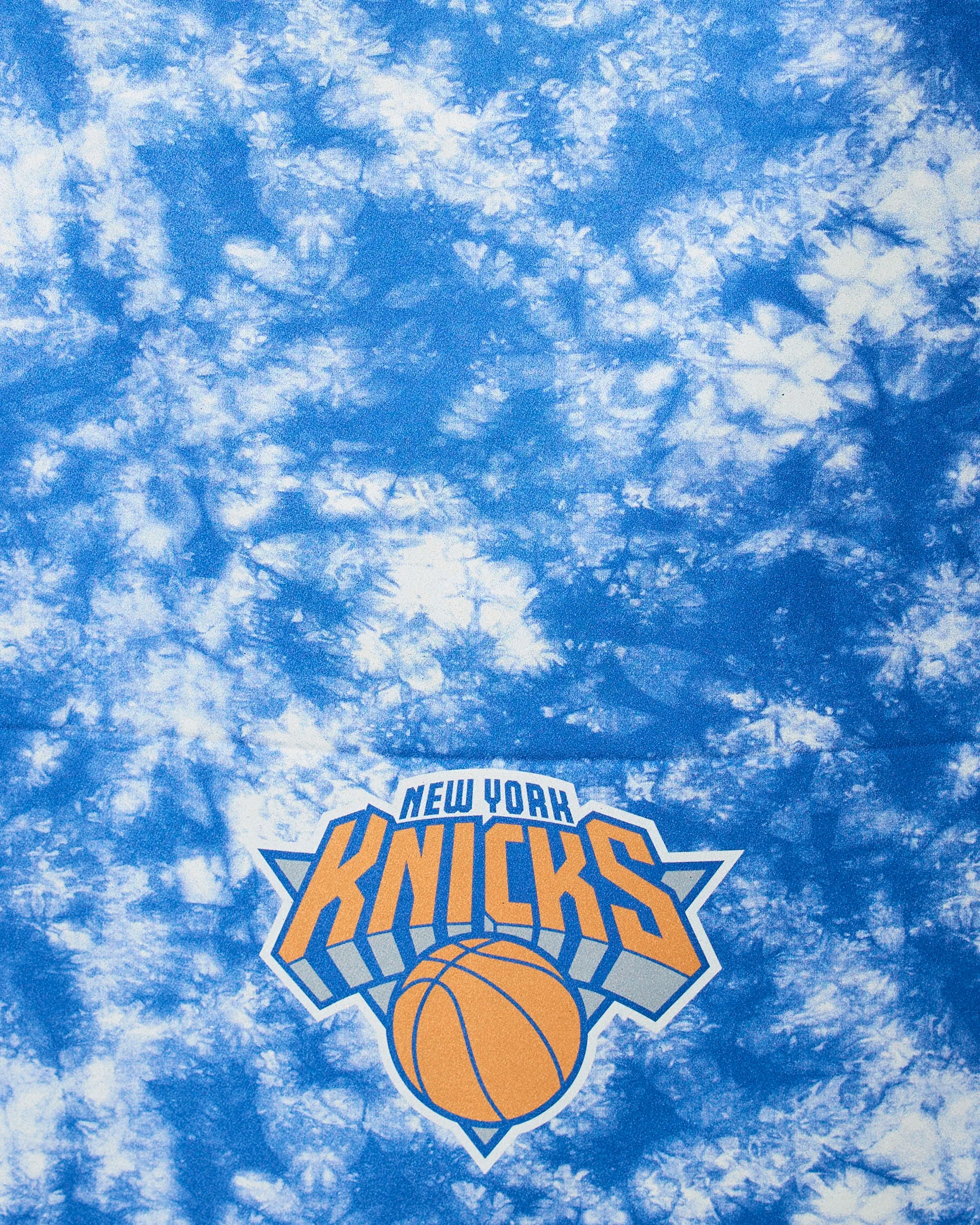 The Knicks Flash by Geometry features a blue and white tie-dye background with the New York Knicks logo, orange basketball, and bold text near the bottom center.