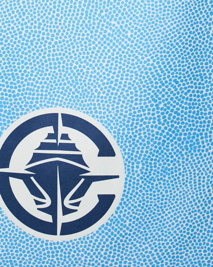 A blue and white abstract design with a circular emblem featuring a cruise ship, set on small blue dots—ideal for the Clippers Grip NBA beach towel by NBALAB x Geometry, crafted from recycled materials.